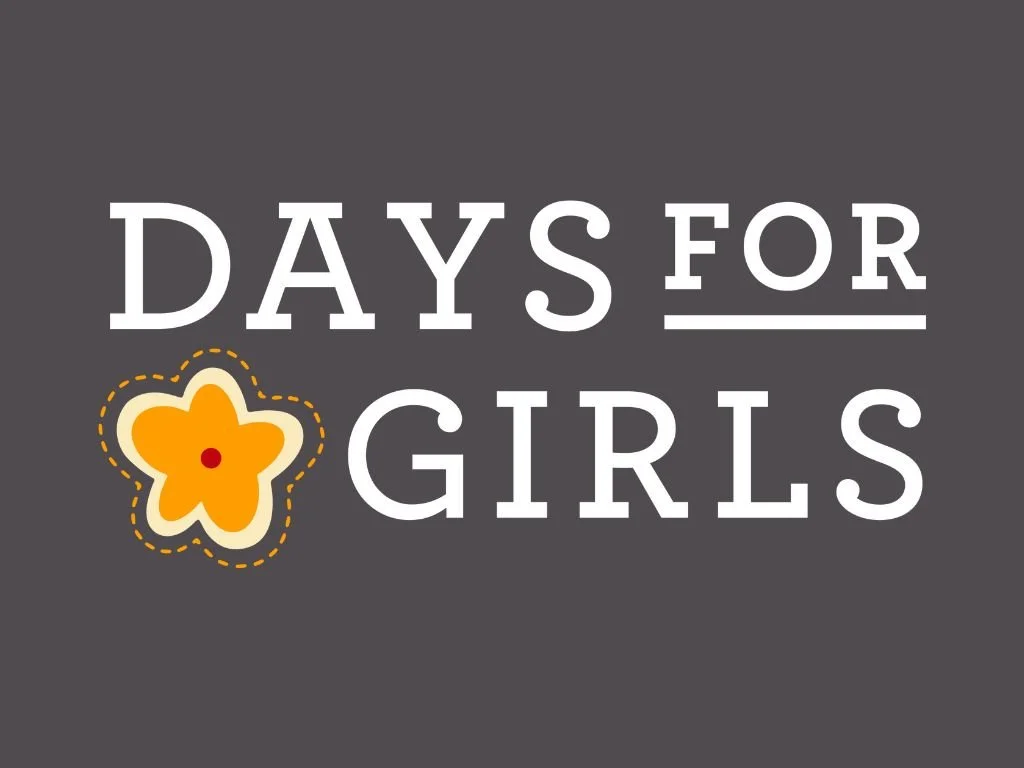 Text graphic reading 'DAYS FOR GIRLS' with a yellow flower illustration on a dark gray background.