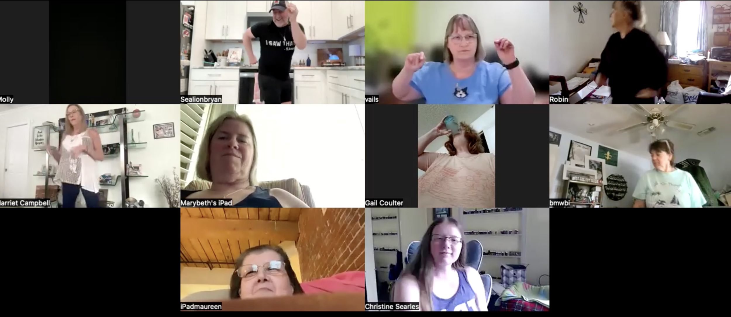 A virtual video call with ten women participating from different indoor locations, some standing, some sitting, some chatting, and others drinking or relaxing.