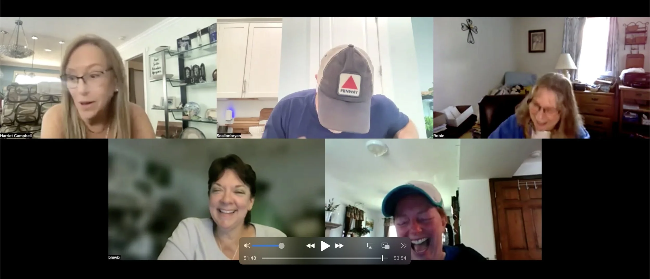 Six people in a virtual video call, smiling and laughing, in a grid layout with three on top and three on the bottom. Each participant appears to be in a different home setting.