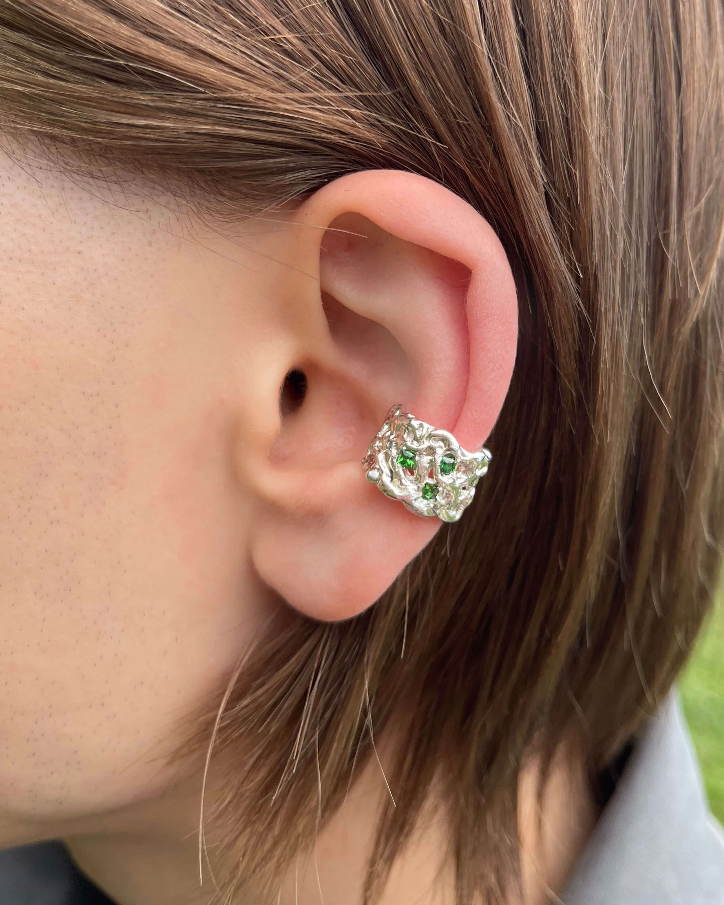 silver thick cuf emerald on ear.jpg