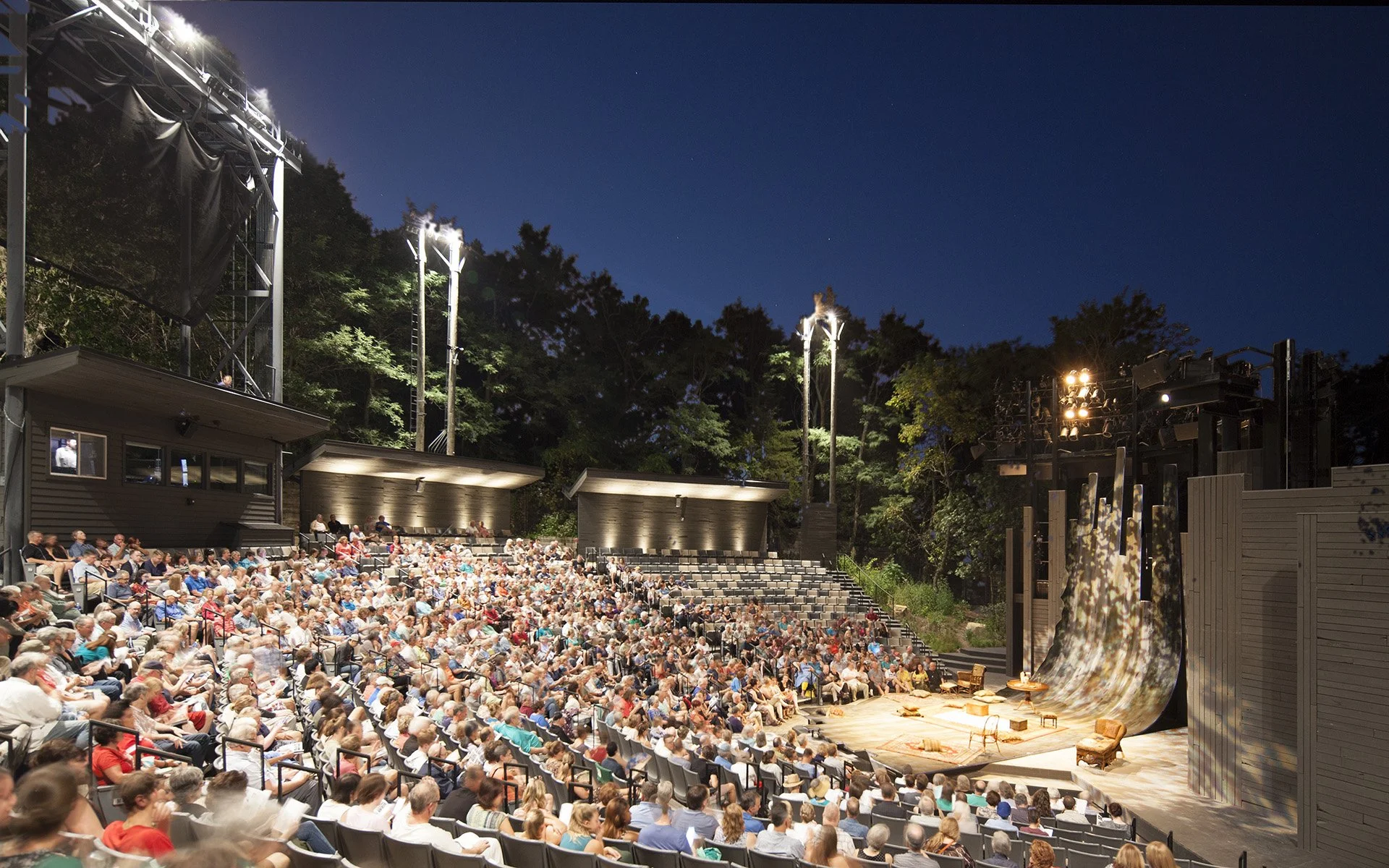 A night shot of the audience at an American Player's Theater production.