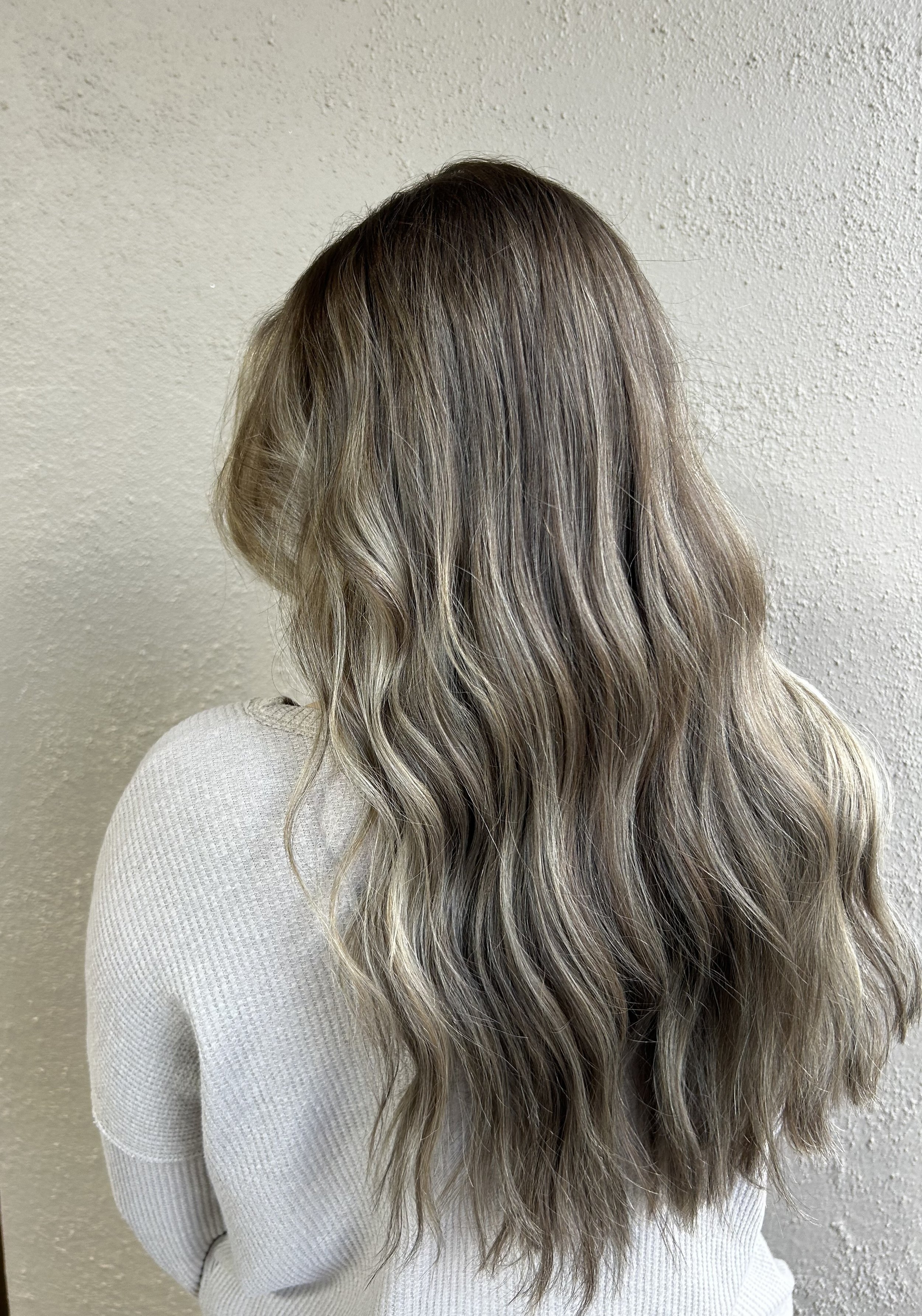 girl with dark hair and blonde highlights