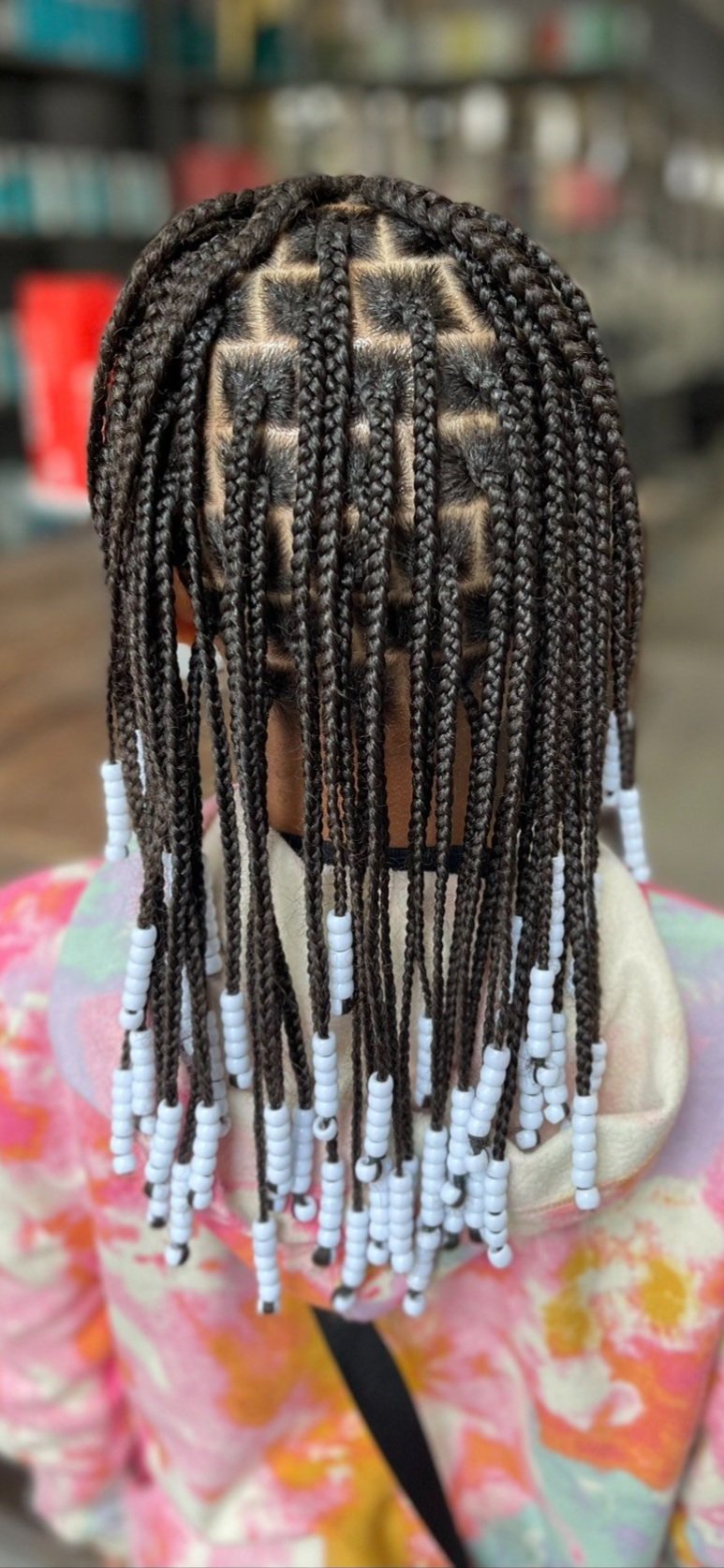 black girl with braids and beads