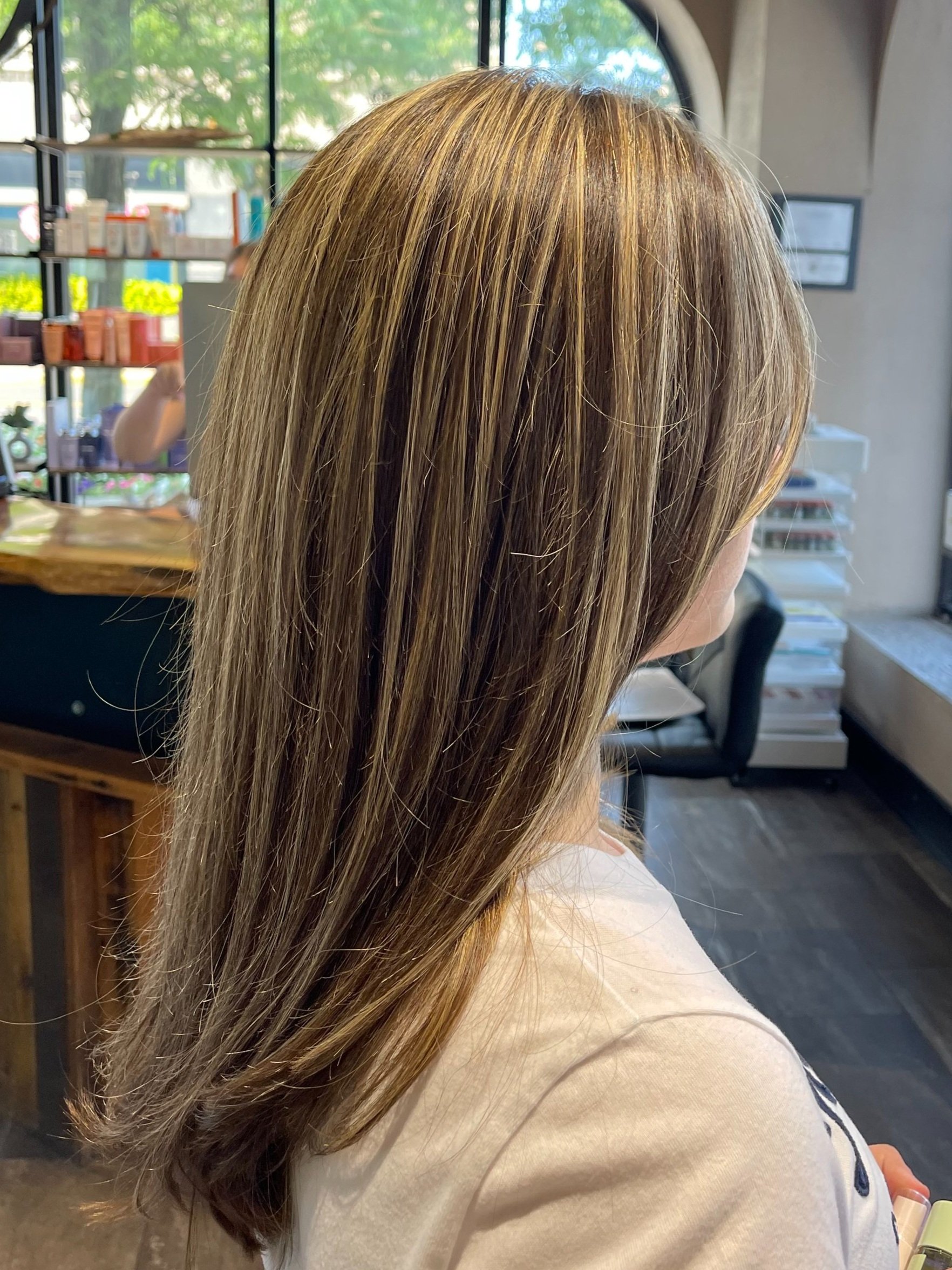 girl with light brown highlights in salon