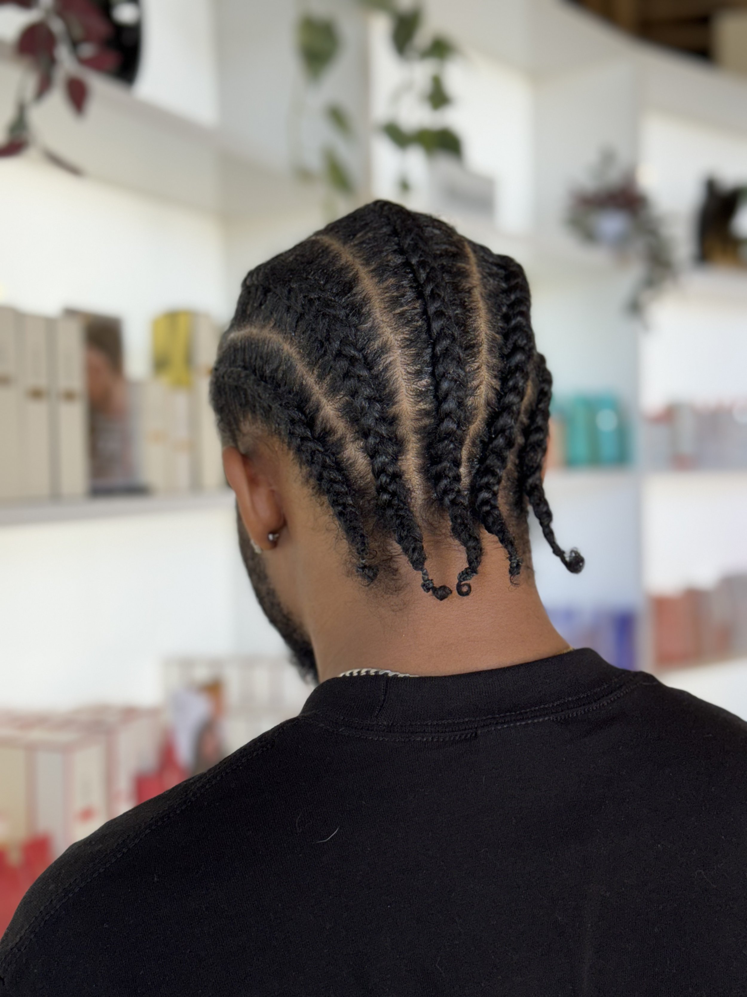 black man with braids in salon