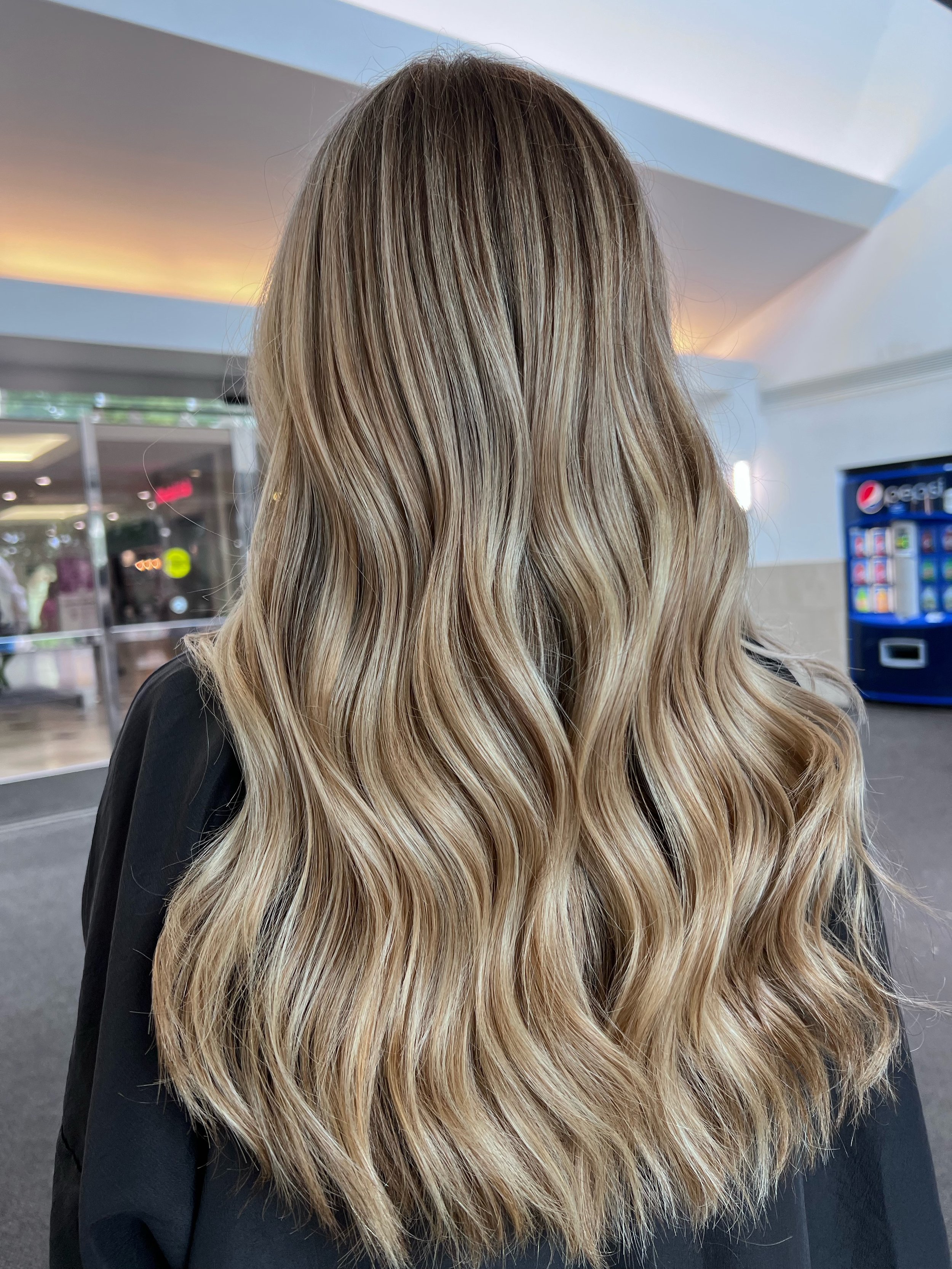 girl with wavy blonde highlights long hair