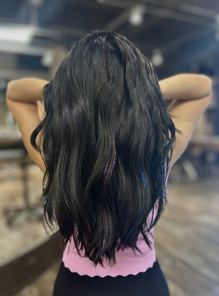 girl with multicolor tinsel in black hair long