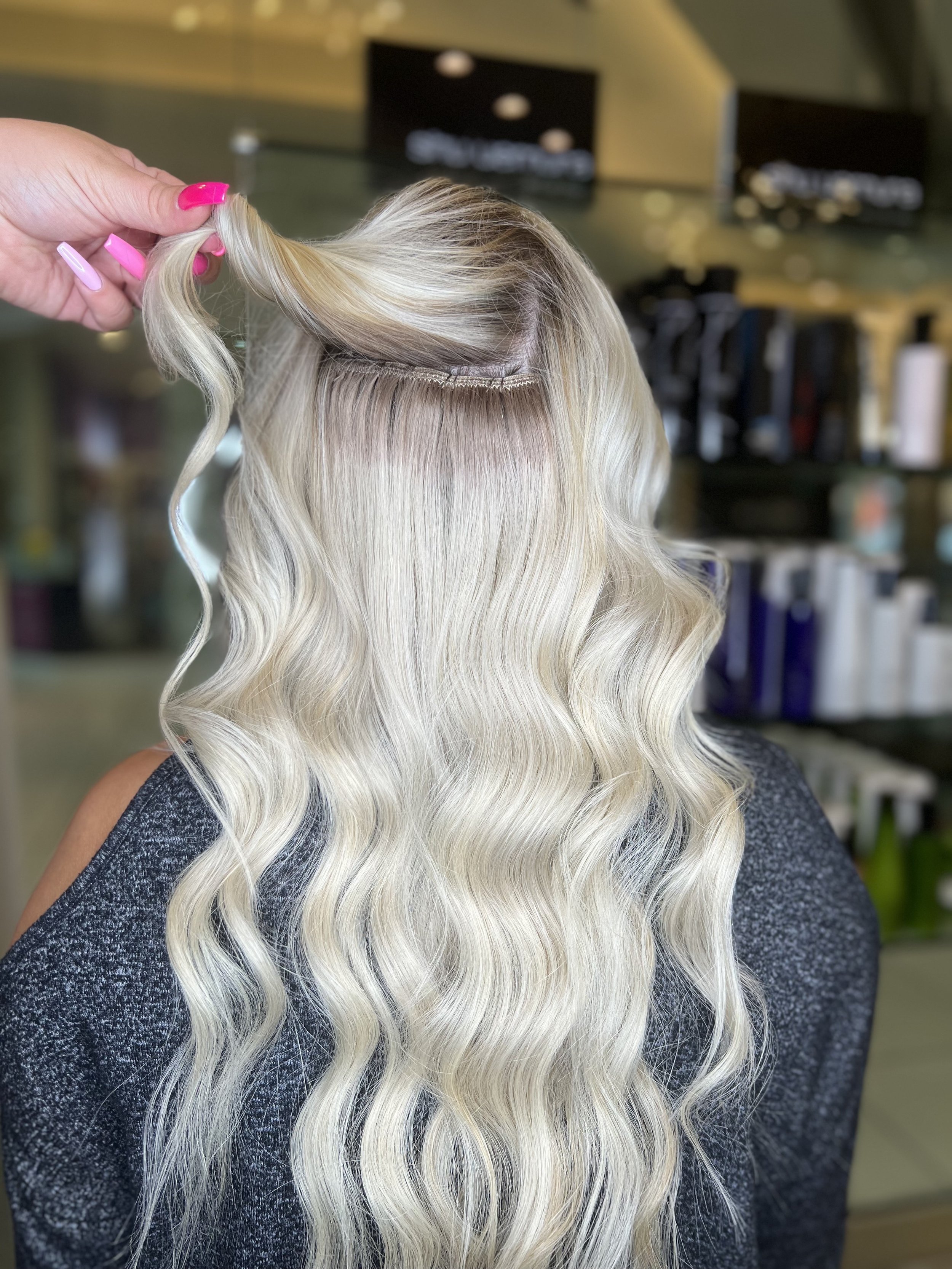 girl with long bright blonde hair with extensions
