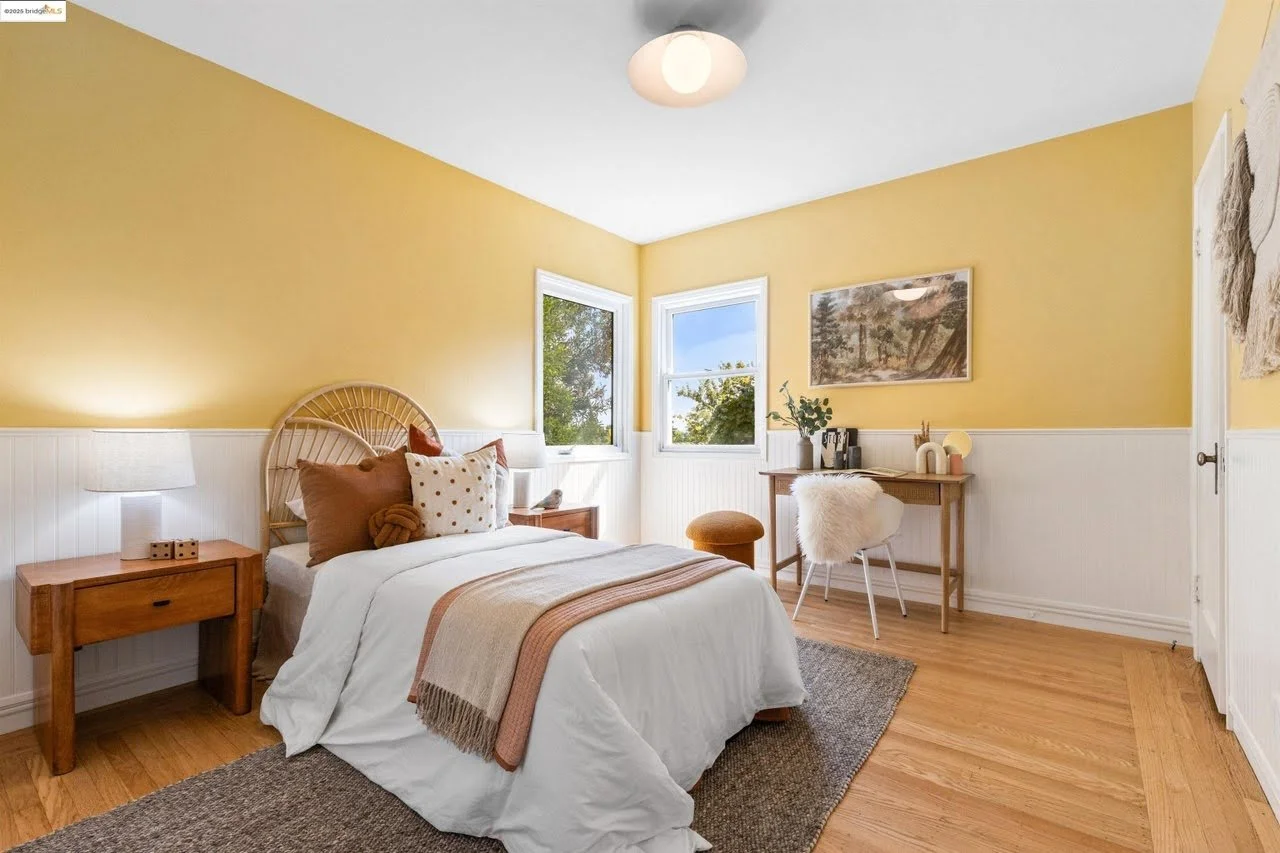 The walls, ceiling, wainscotting, and trim were all painted. The walls are a bright yellow color while the wainscoting is a crisp white. The paint colors totally transformed this bedroom in the Oakland Hills.