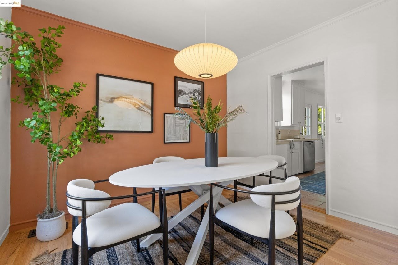 The ceiling, walls, and trim got a fresh coat of white paint in this dining room in the Oakland Hills. One accent wall is painted a terracotta color and creates a huge impact.