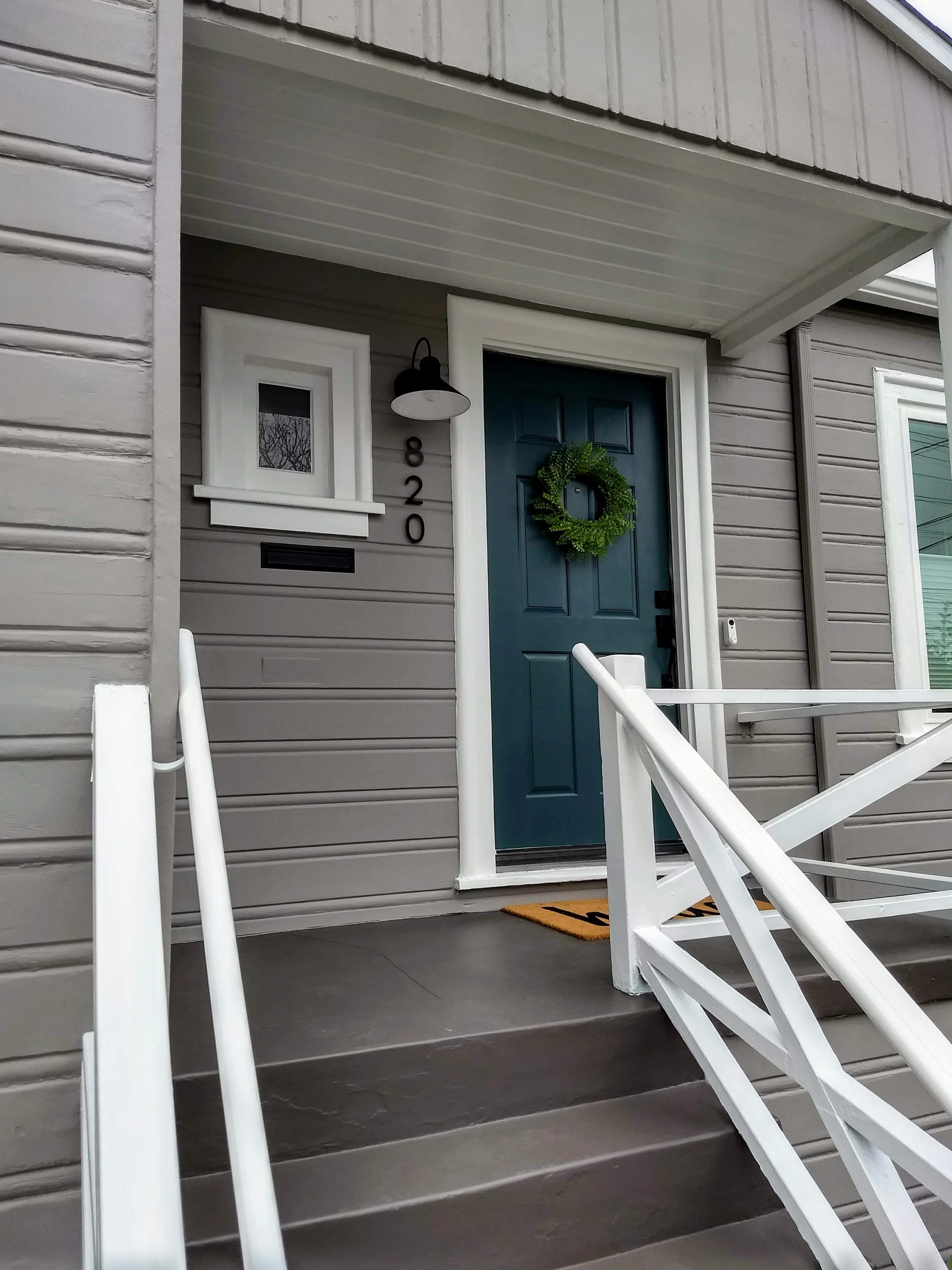 Exterior house painting of siding, trim, and front door completed in El Cerrito, CA