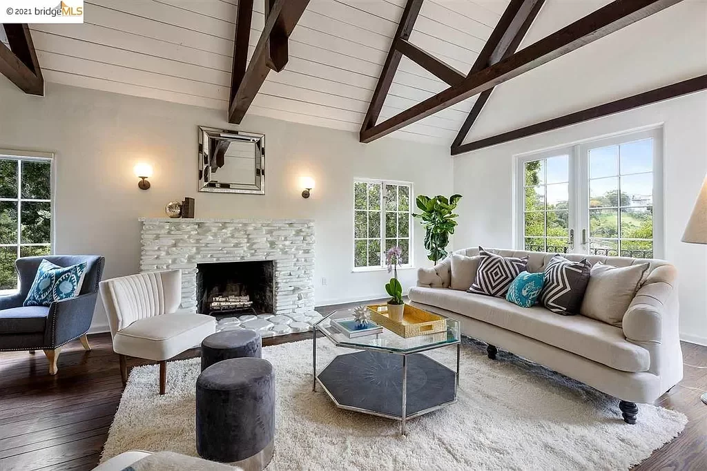 Paint was applied the shiplap ceiling, the walls, the trim, and to the stone fireplace in this living room located in the Oakland Hills.