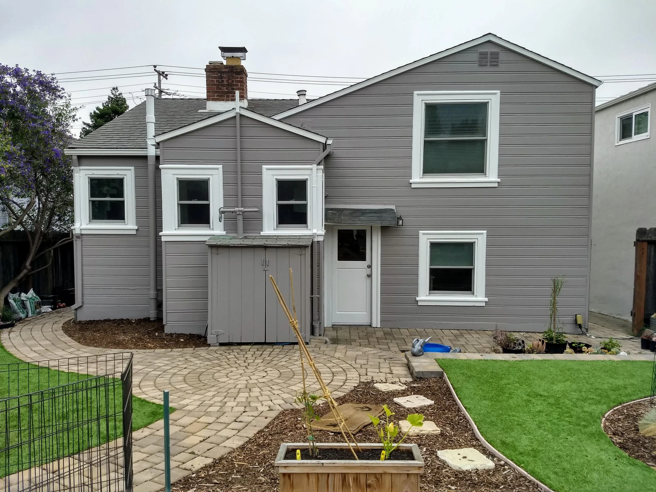 Exterior house painting of siding, trim, and front door completed in El Cerrito, CA