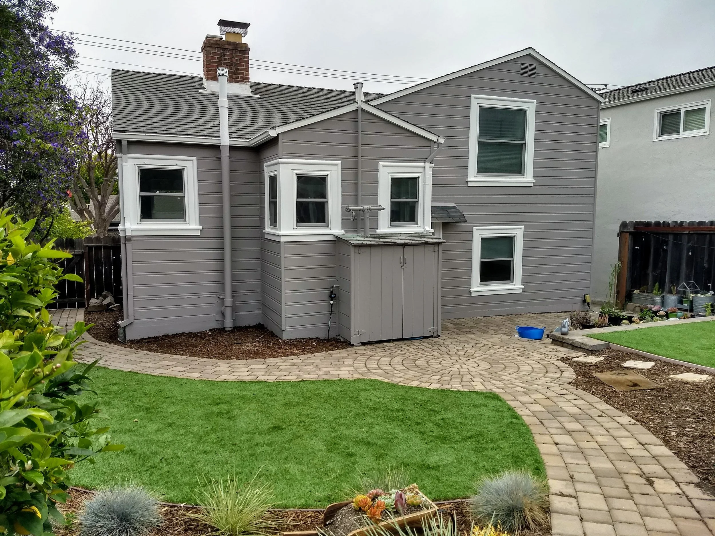 Exterior house painting of siding, trim, and front door completed in El Cerrito, CA
