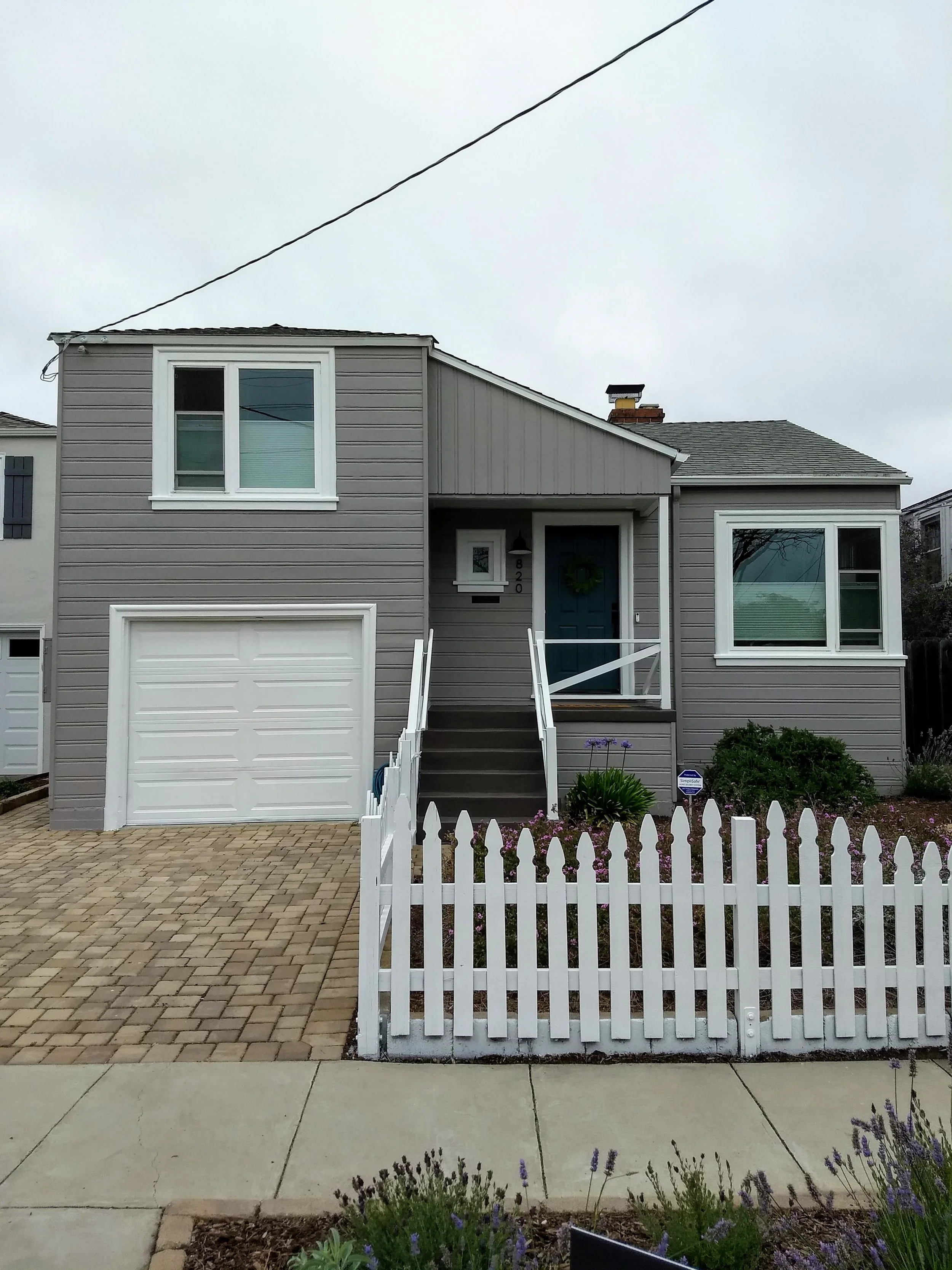 Exterior house painting of siding, trim, and front door completed in El Cerrito, CA
