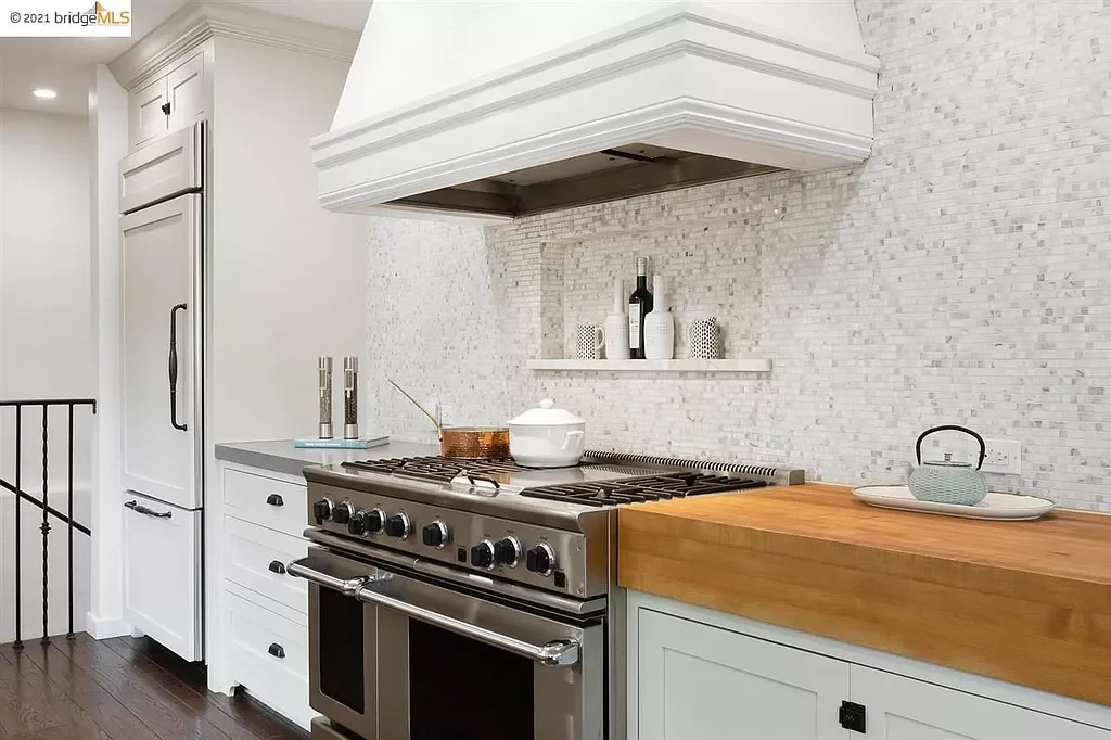 Paint was applied to the kitchen range hood with durable paint to match the cabinets for this kitchen in the Oakland Hills