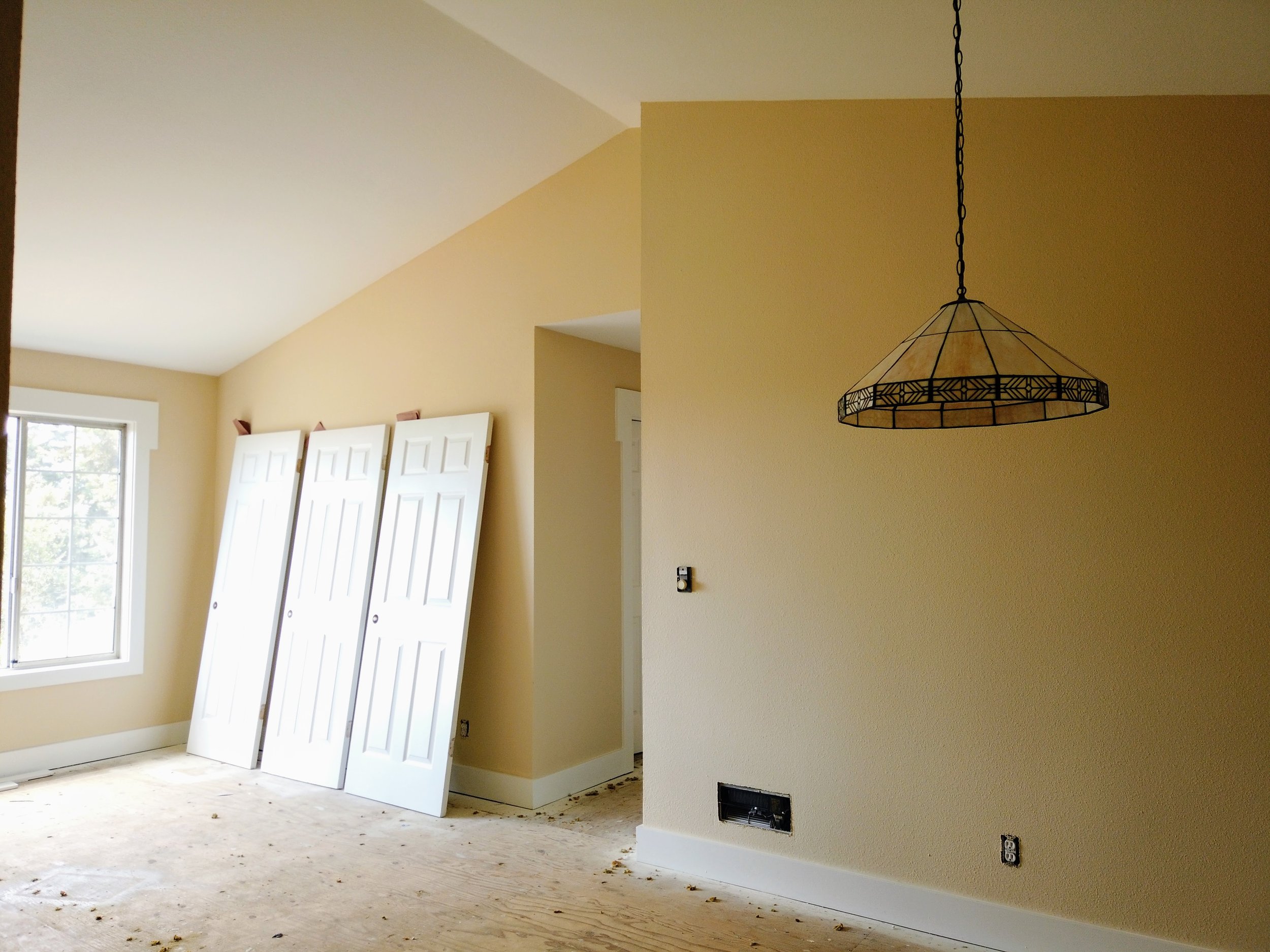 A fresh coat of paint was applied to the trim, the ceiling, the doors and the walls in this entry and living room for a rental property located in the Dimond district of Oakland.