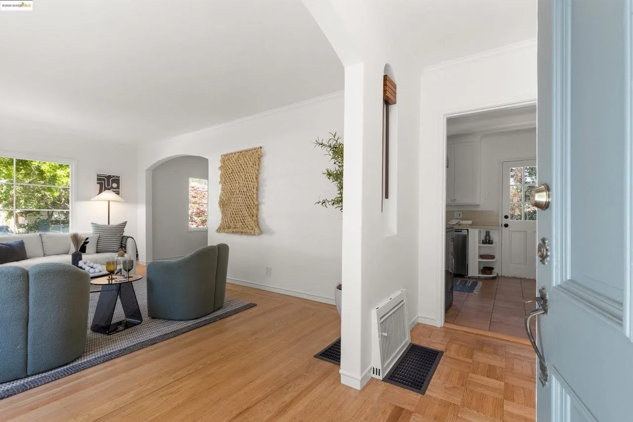 The ceiling, walls, and trim got a fresh coat of white paint in this entryway and living room in the Oakland Hills.