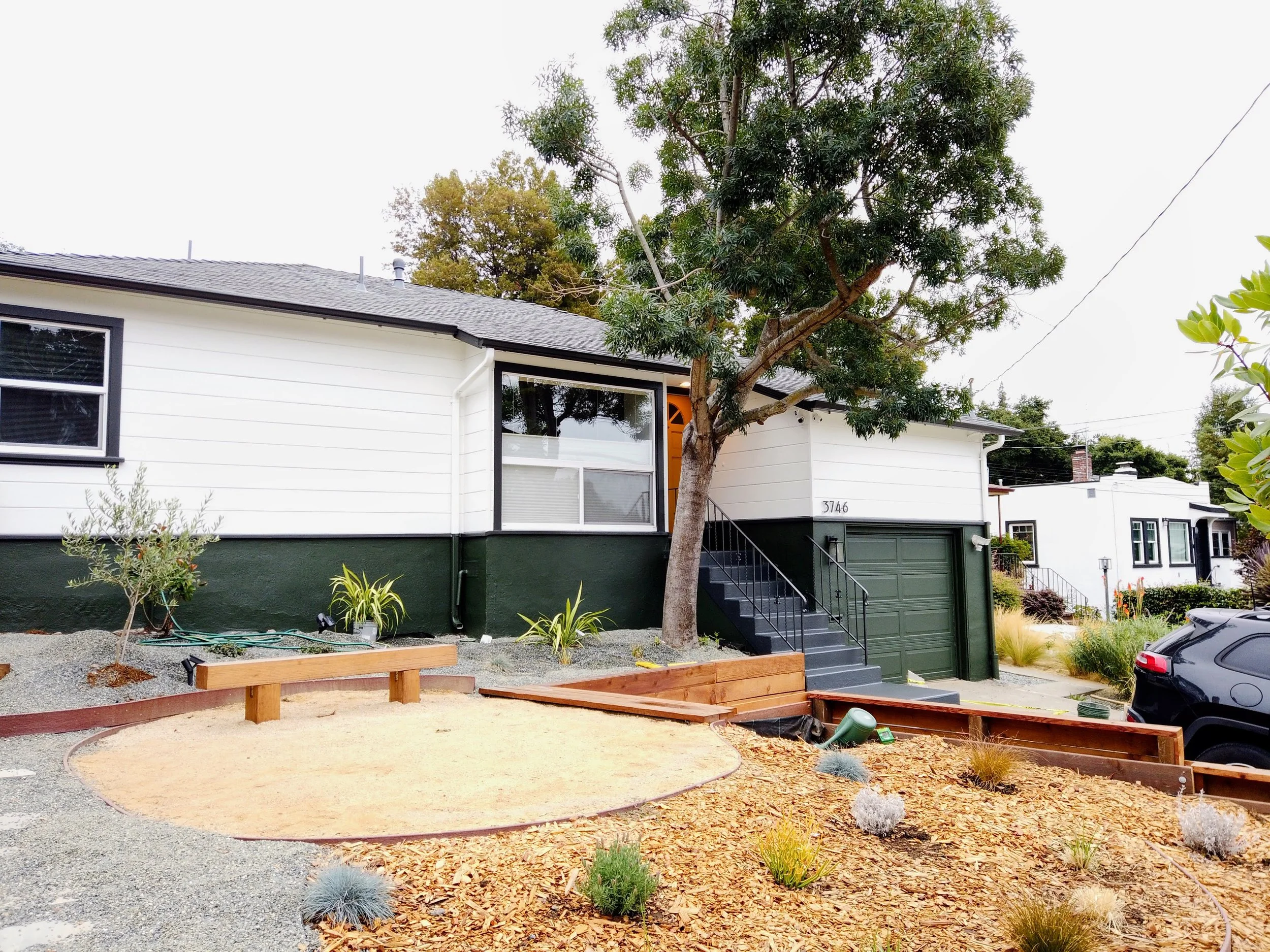 Exterior home transformation with new paint on siding, trim, and doors in Oakland, CA.