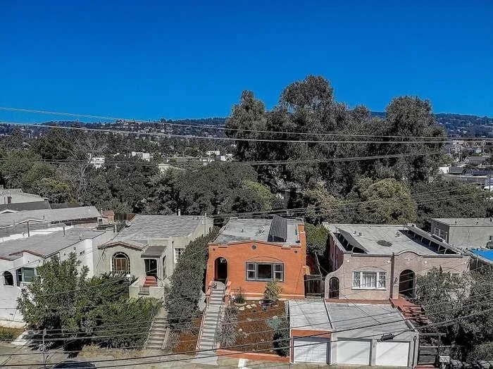 Residential exterior repaint with smooth siding coverage and clean trim lines in the East Bay.