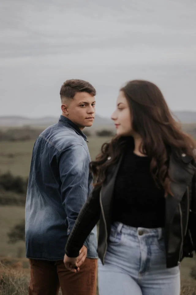 A woman and a man walking away from each other