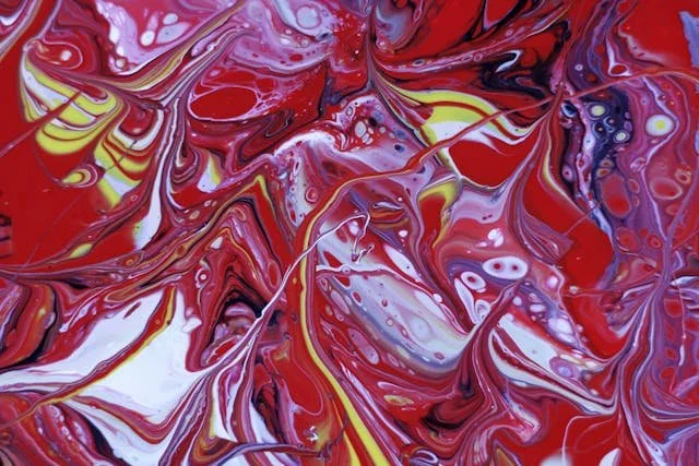 colorful abstract painting features dynamic red and yellow swirls, creating a vivid visual impact