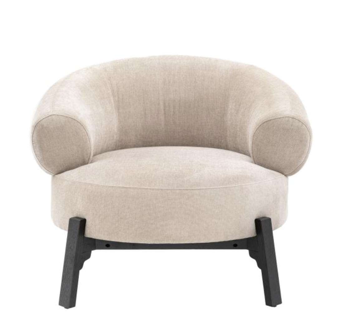 Perfect for getting cosy this well cushioned and extra comfy armchair will become the stand out feature of any space The curved wrap around back and round seat is supported by a bold dark wood base frame and legs, making it an eye catching addition t