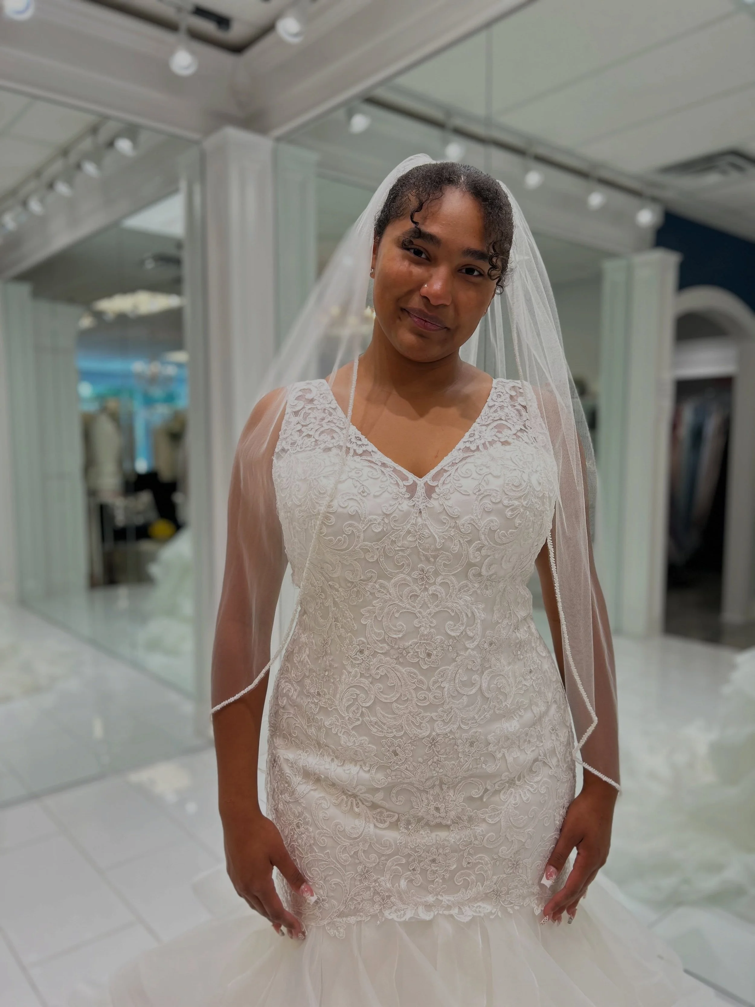 Lace, sparkle, and a whole lot of WOW 🤩 This stunning mermaid gown features frosted Alencon lace, figure flattering bodice, and a dreamy flounced organza skirt 🤍 And that fingertip veil?! The perfect finishing touch 🥰 Ready to find your dream dres