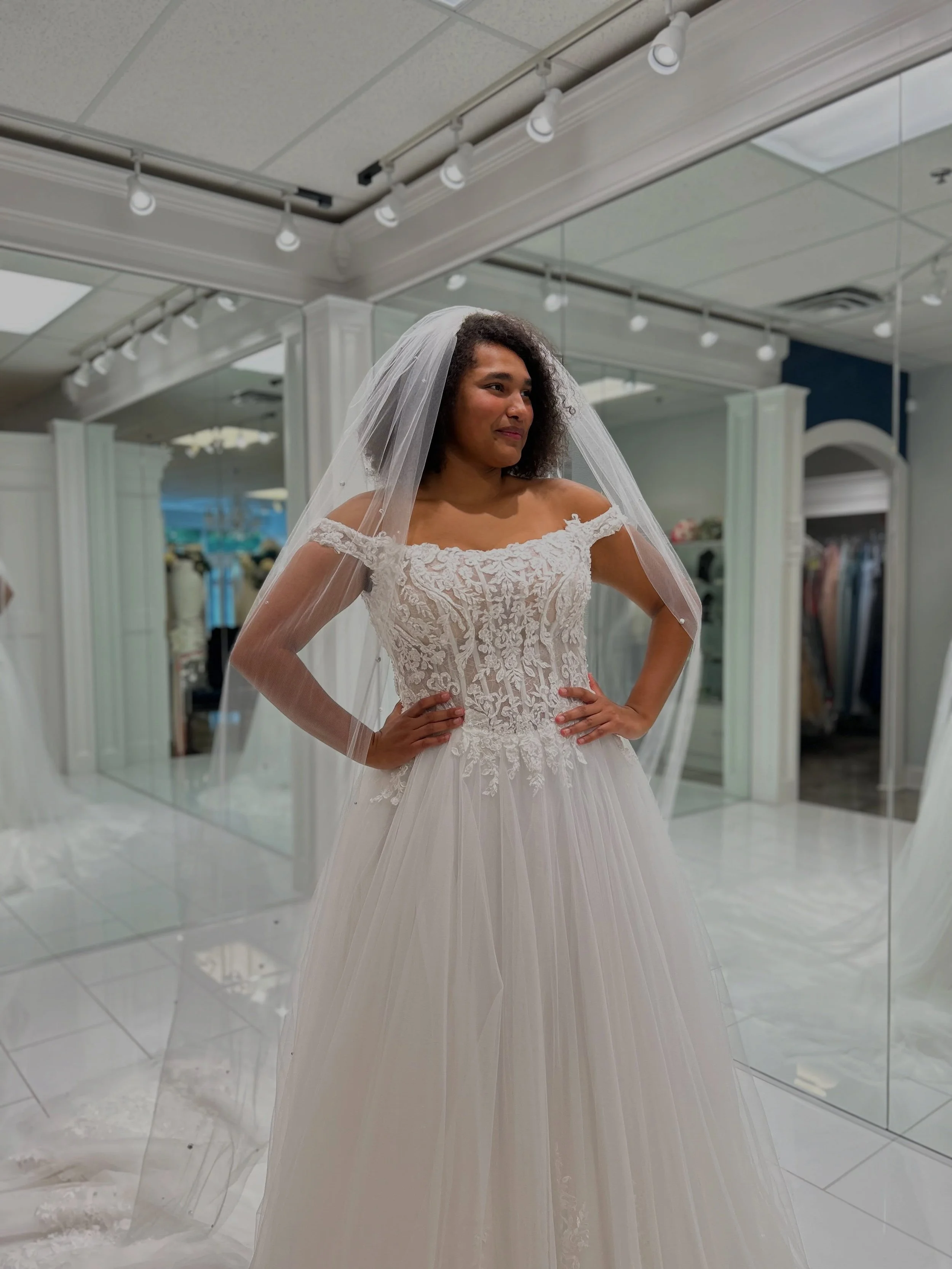 This dreamy ball gown brings all the romance with its chantilly lace, corset bodice, crystal details, and airy tulle skirt, and that stunning cathedral length rhinestone veil 💍☁️ Would you say I do in this gorgeous bridal look? 👀 
.
.
.
#nataliesbr