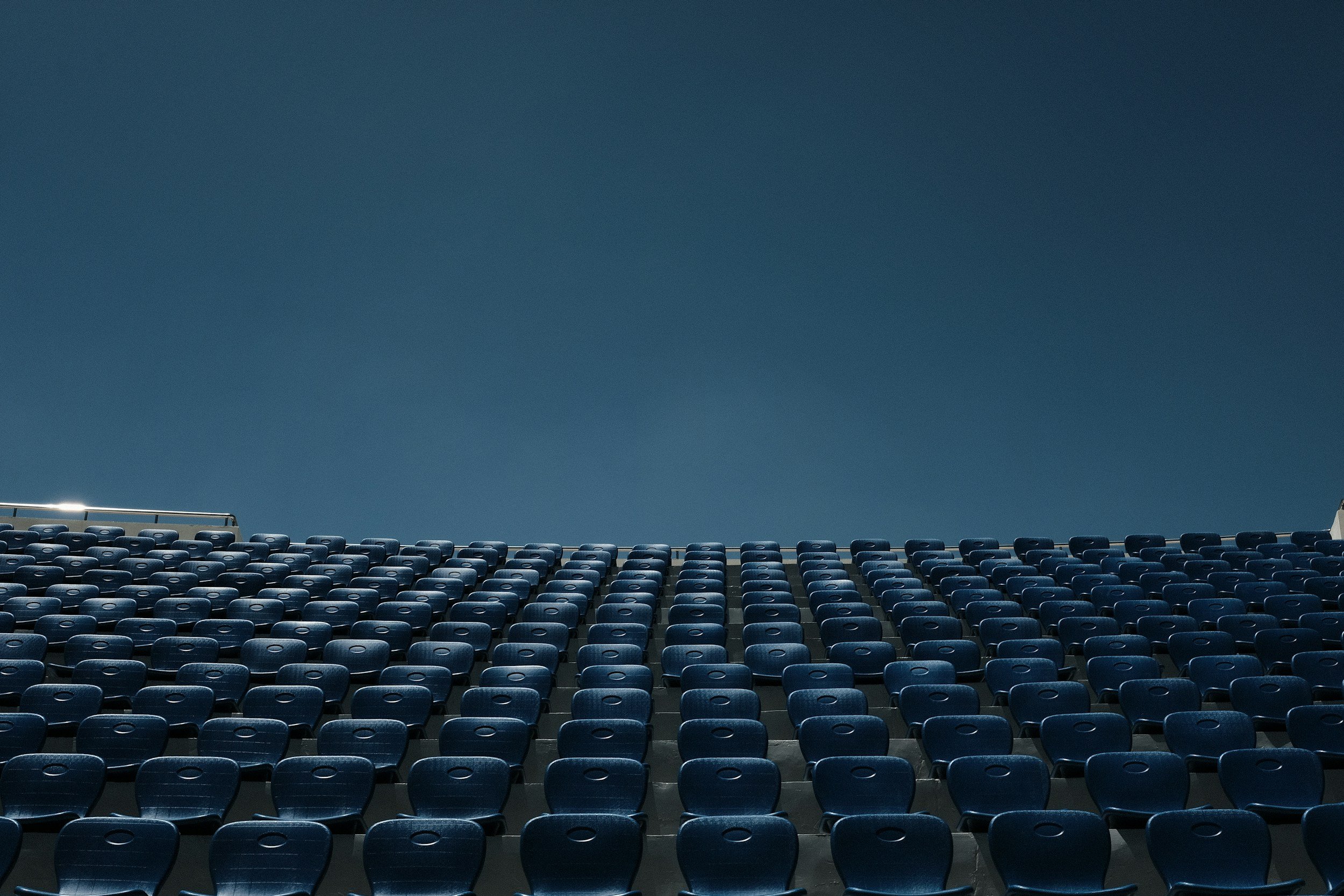 large lecture room full of lined-up chairs  