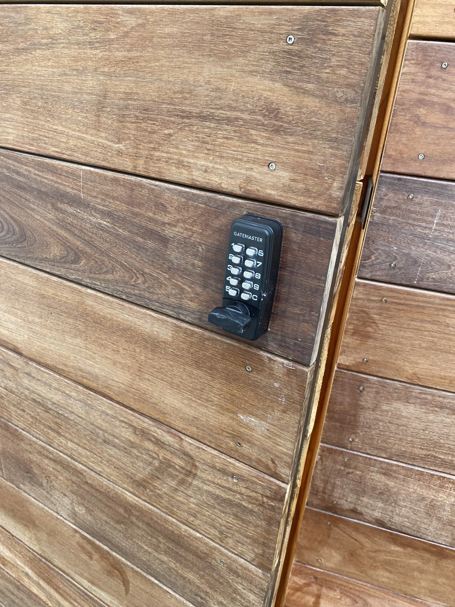 Wooden gate with keypad lock