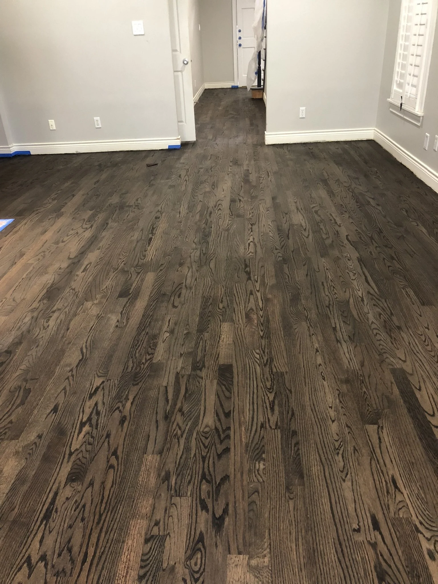 Room with newly installed dark hardwood flooring
