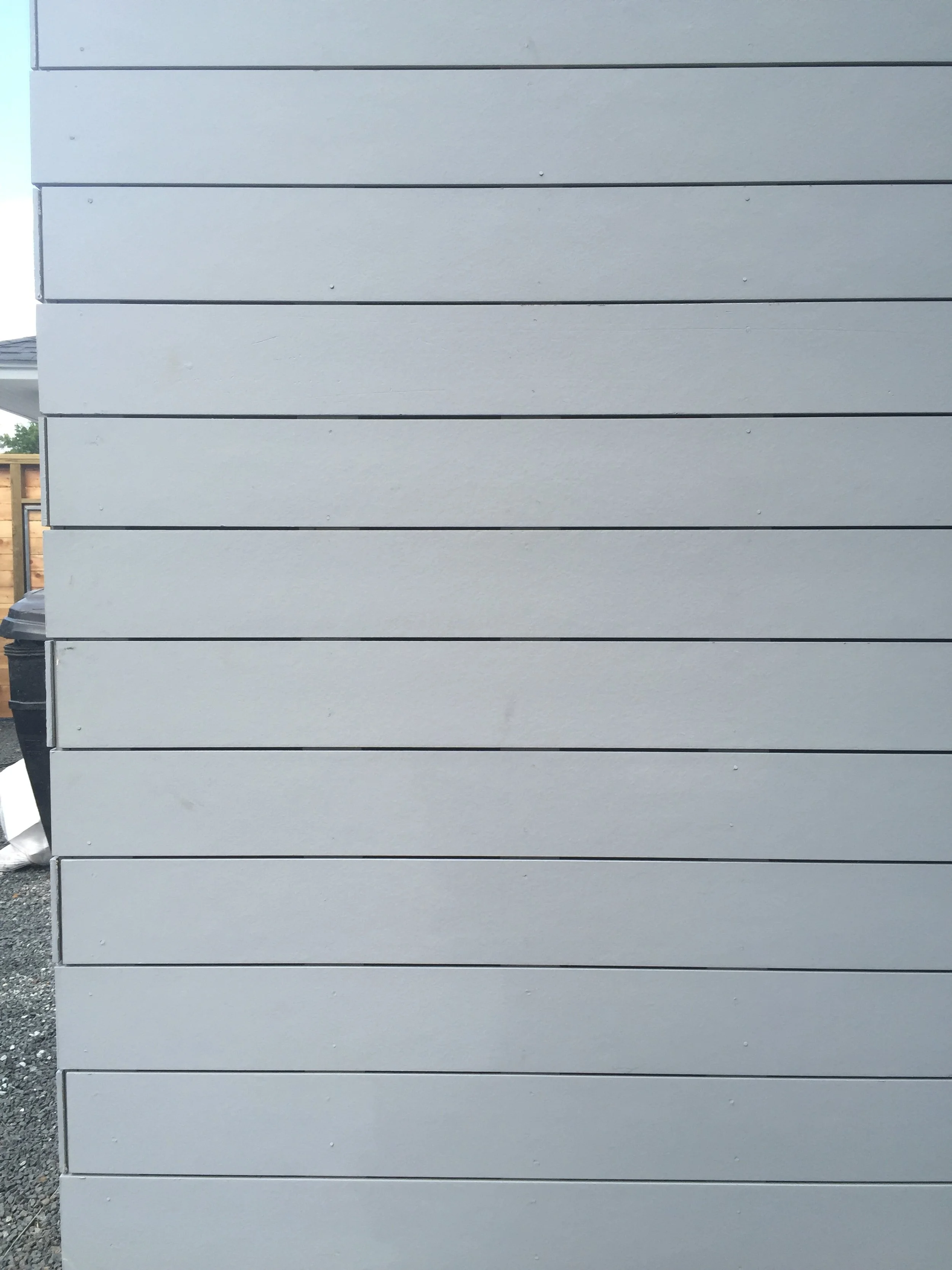 White horizontal shiplap siding on an exterior wall.