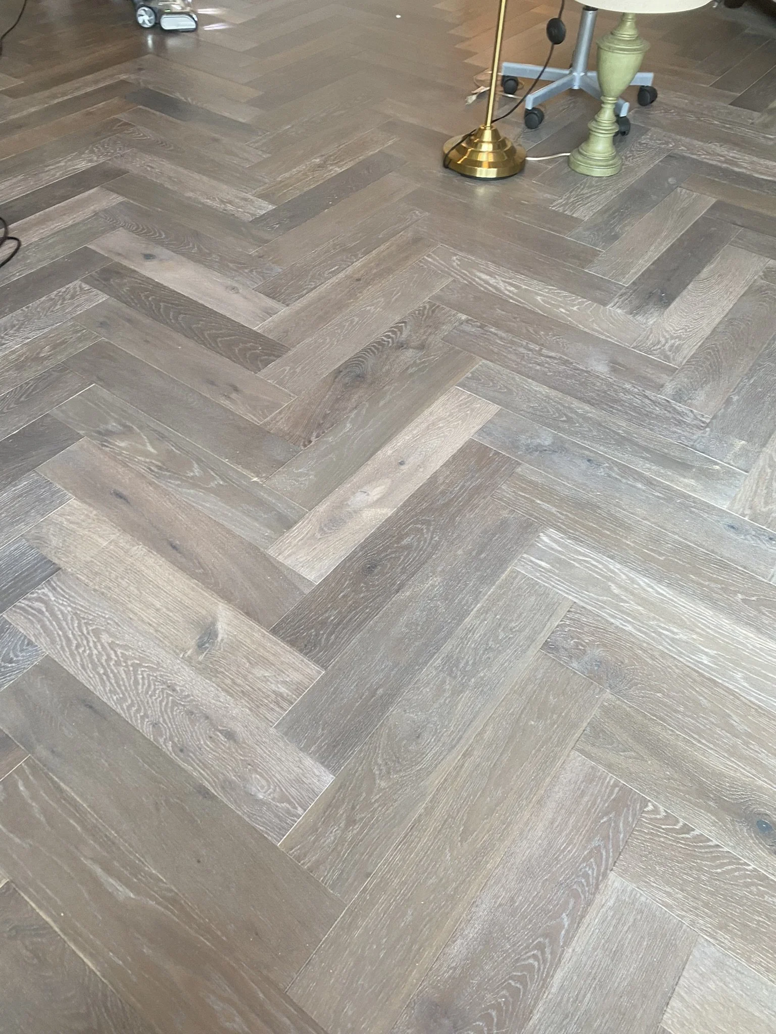 Herringbone wood floor with office chair and lamp