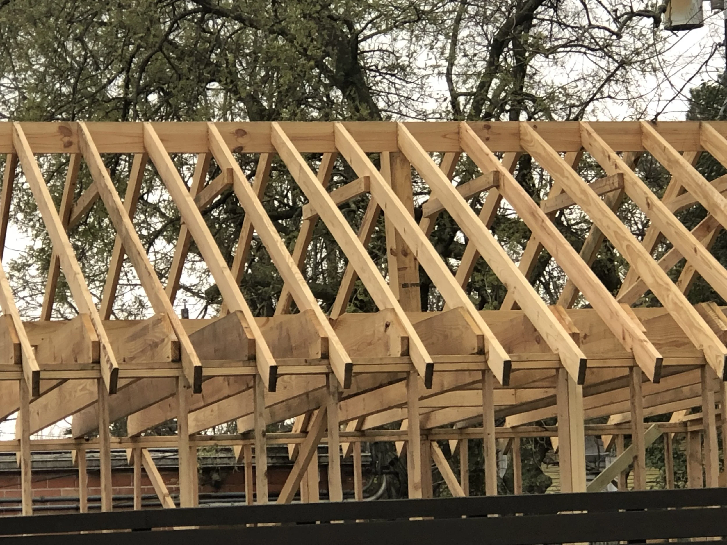 Wooden roof trusses in construction.