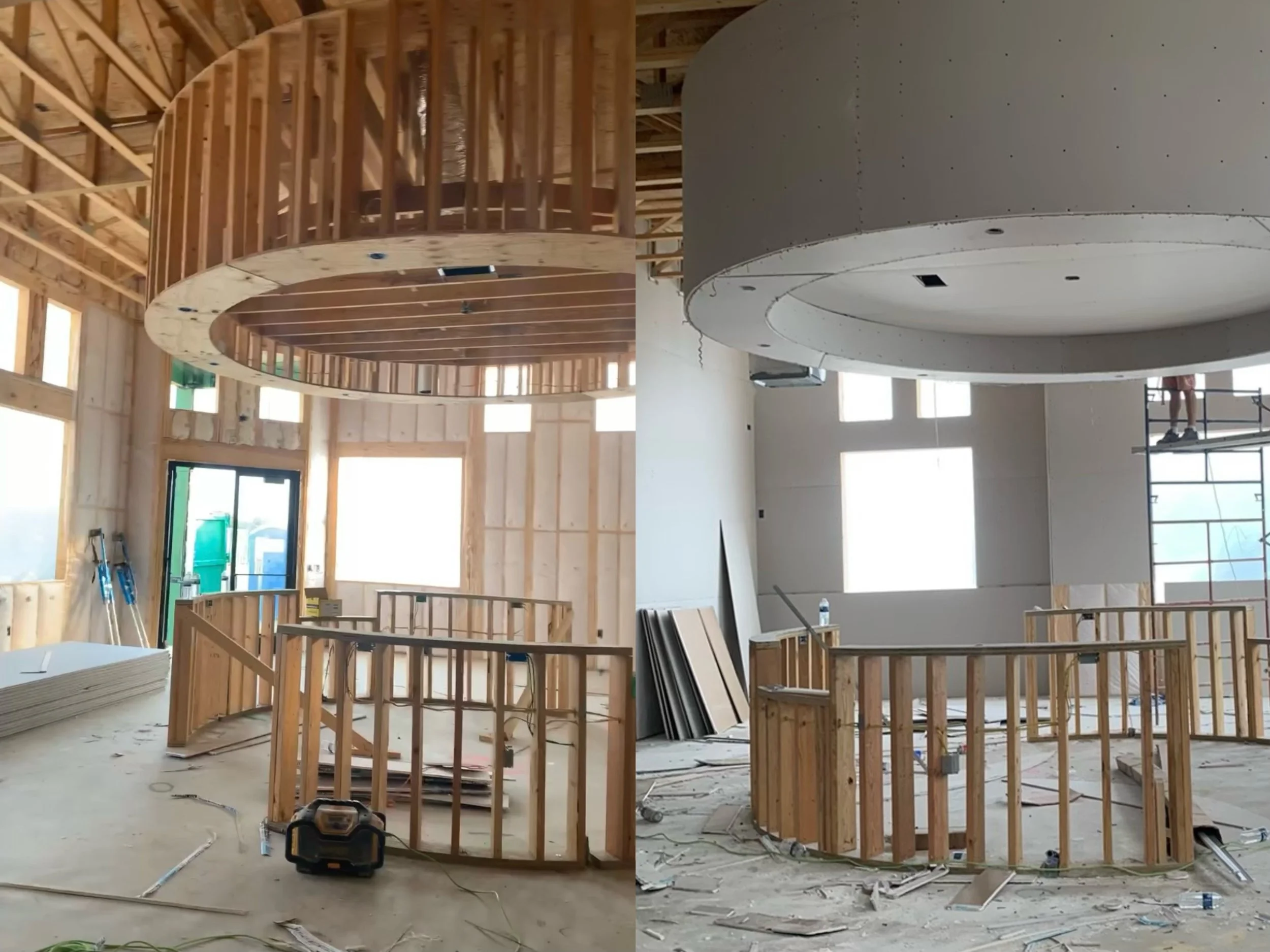 Interior construction of a circular structure with wood framing and drywall installation in progress; scaffolding visible.