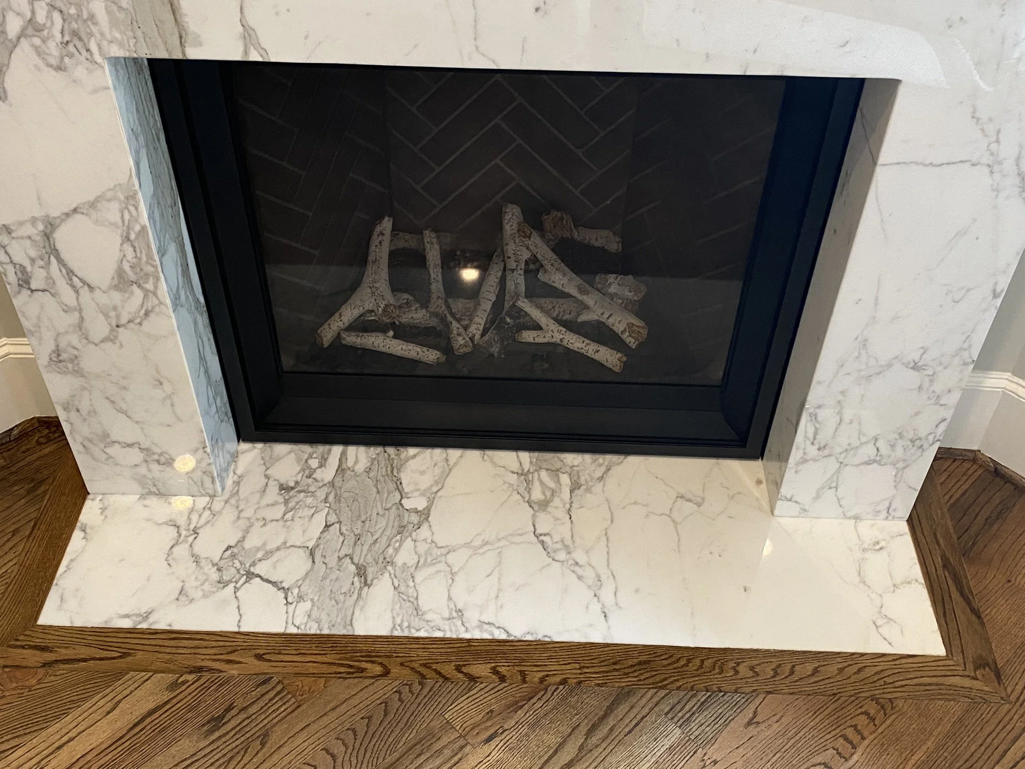 Marble fireplace with decorative logs
