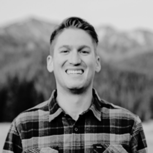 Black and White headshot of Dallas Crum, Co-Founder and CEO of Proud Impact Collective