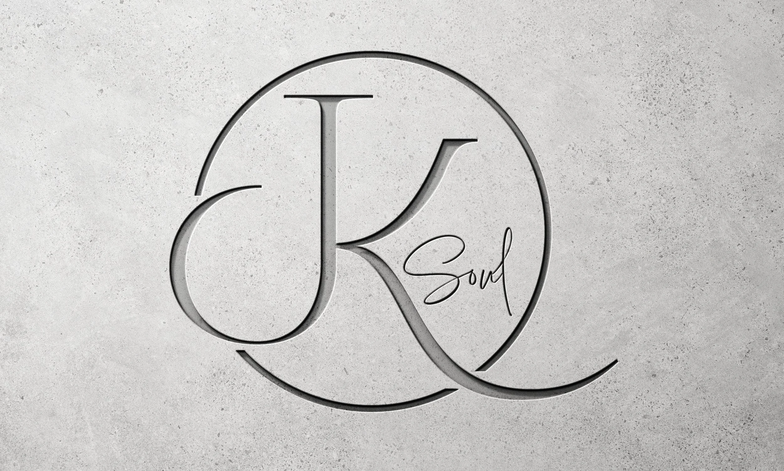 Modern wall logo featuring a large cursive letter 'J', 'K', and the word 'Soul' inside a circular outline, on a concrete background created by RGFX for jksoul.com