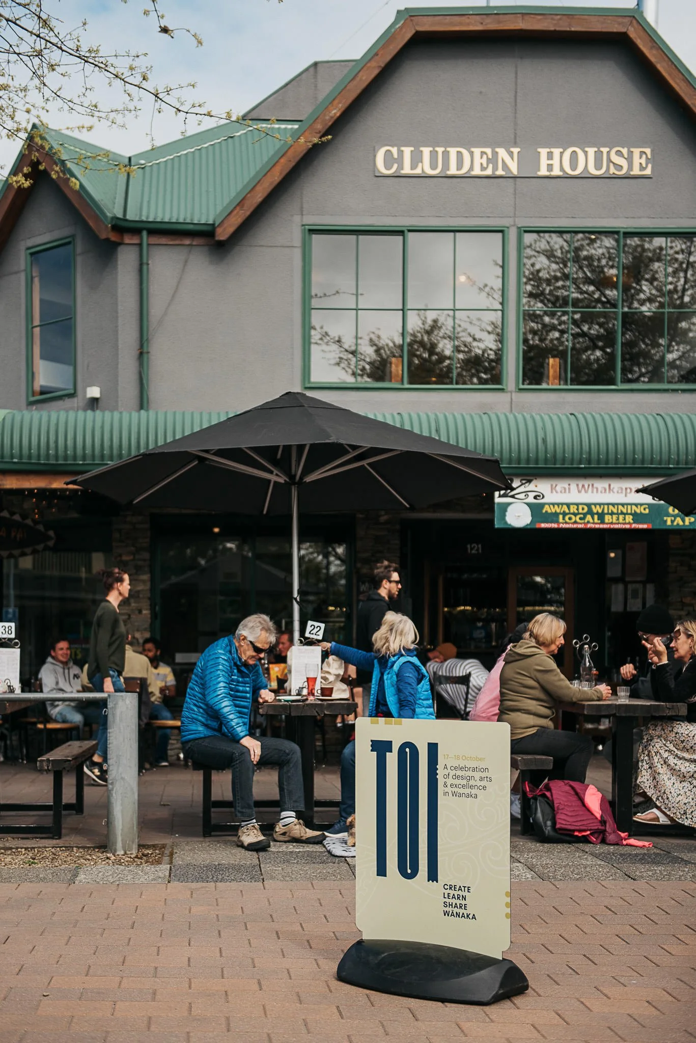 Sign in front of people at a cafe