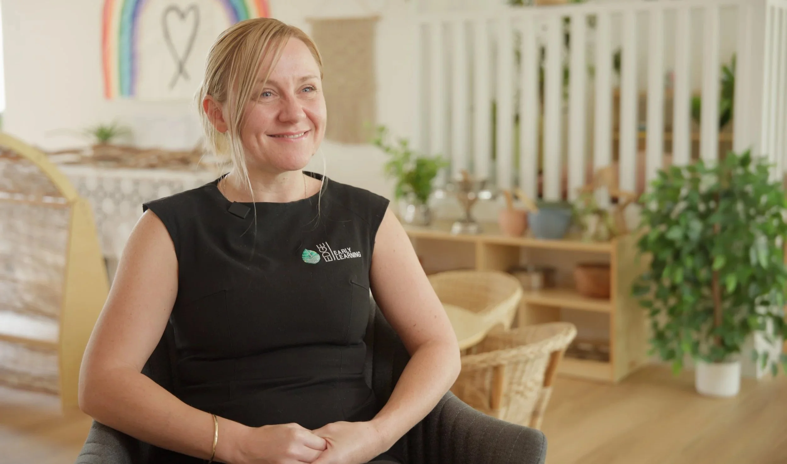 Two men clinking martini glasses filled with clear liquid, smiling and celebrating indoors.
