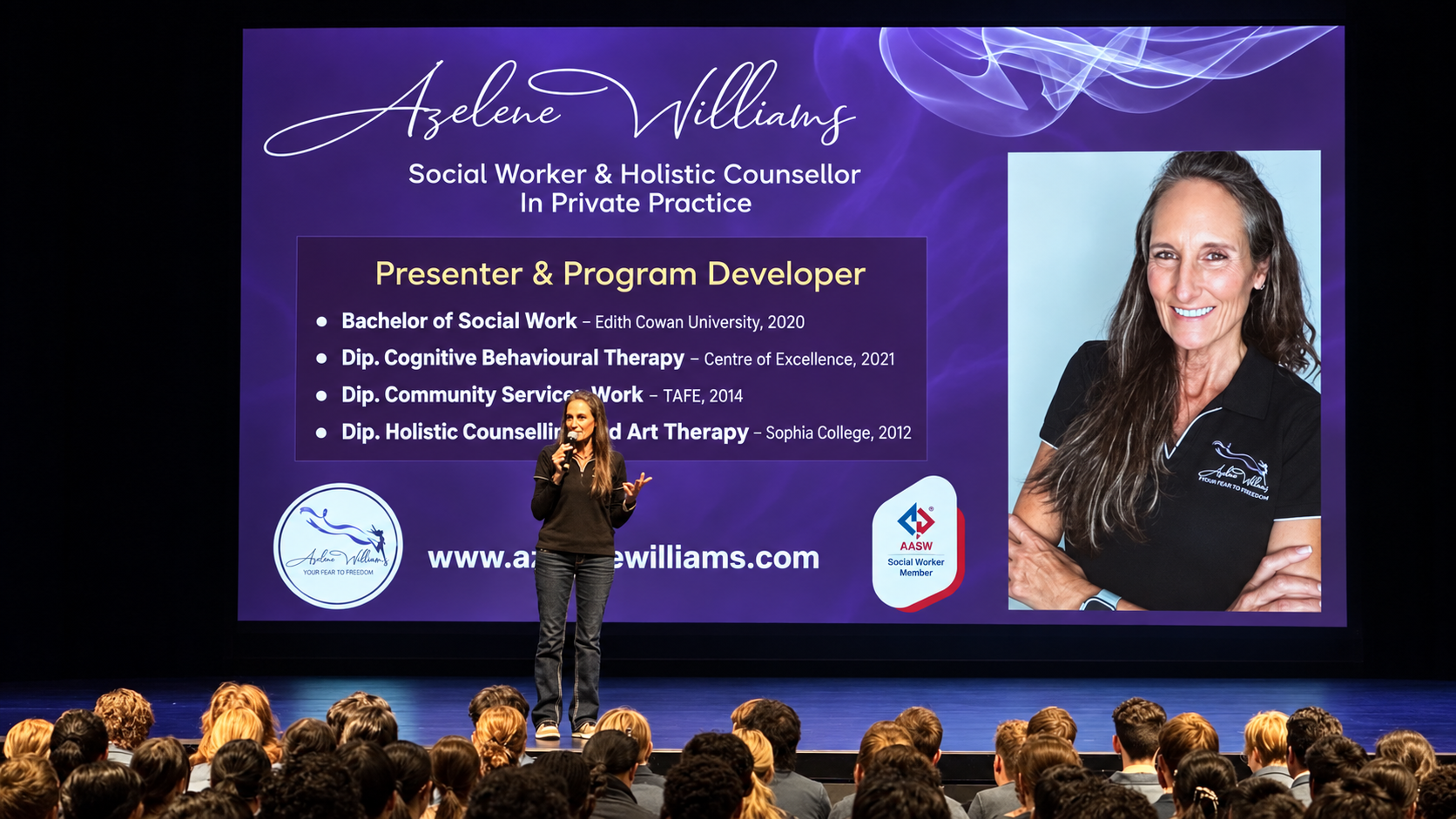 The screen displays information about Azelene Williams, a social worker and holistic counselor, including her credentials, certifications, photo, and website. The audience is seated in rows and attentively listening.