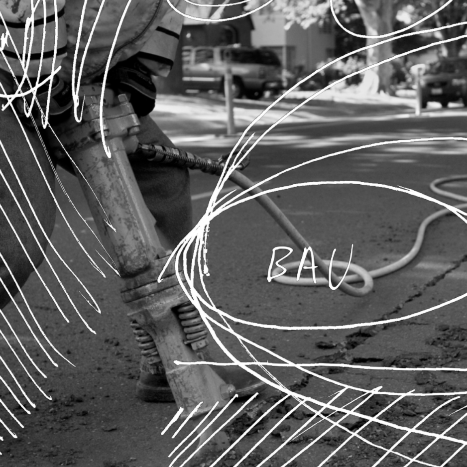 Close-up of a worker operating a jackhammer on the street with chalk drawings and the word "Bau" written on the image.