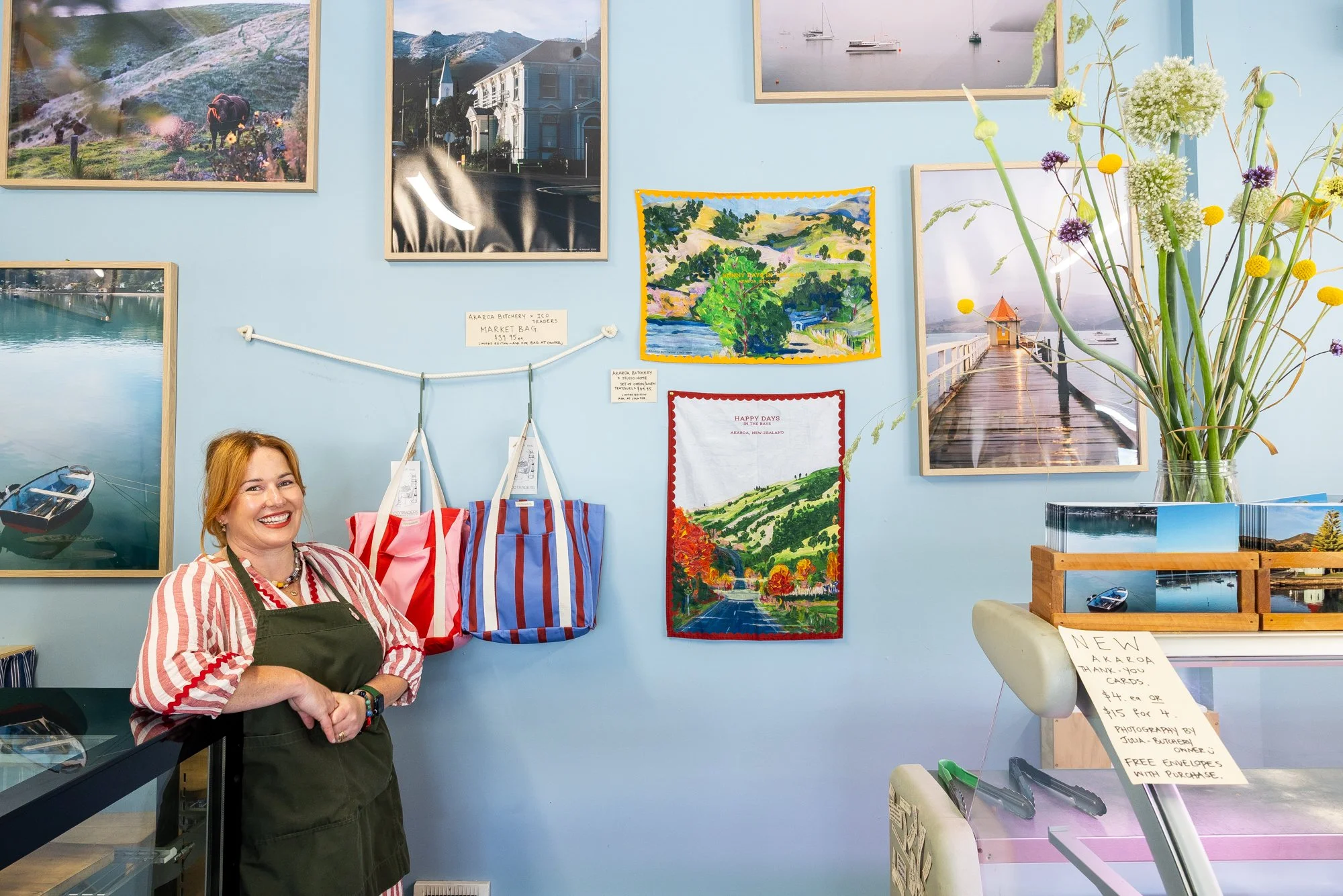 Julia Atkinson-Dunn inside the Akaroa Butchery and Deli with examples of her teatowels she has designed for the store and her market bags in collaboration with Ico Traders.
Photography by Daniela Aebli for Neat Places. 