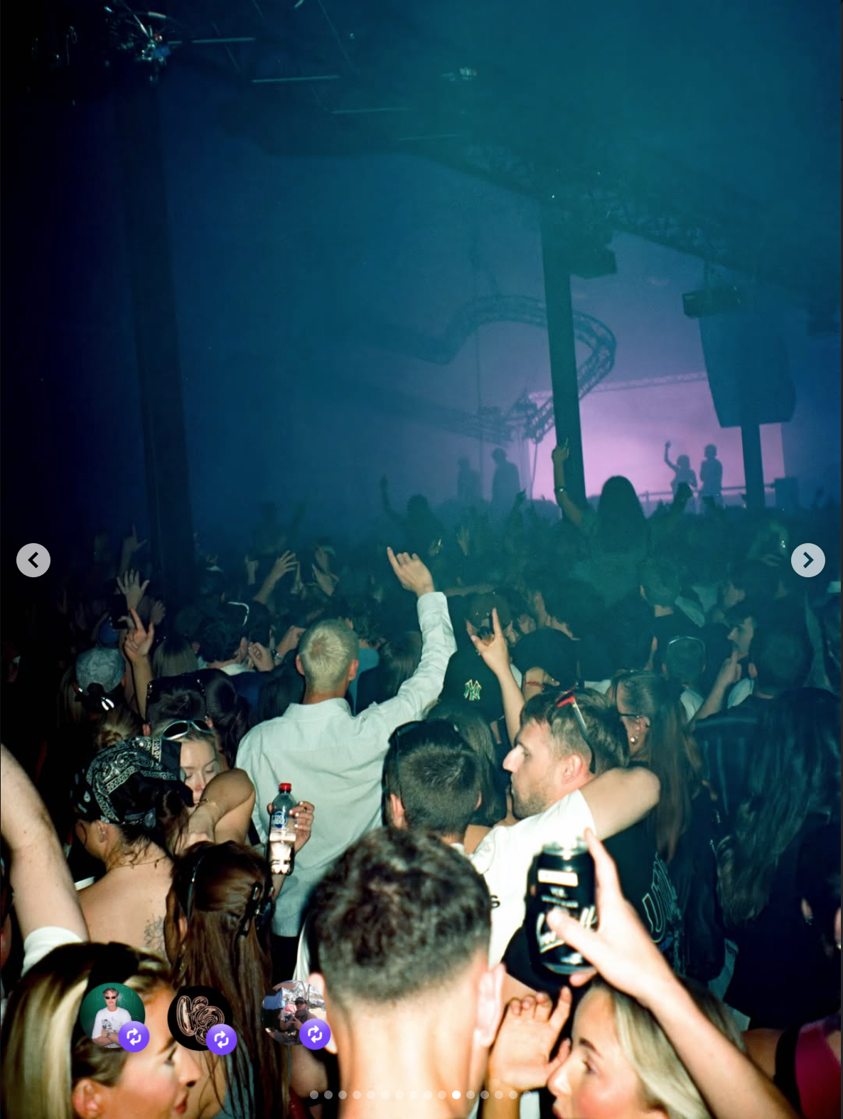 Crowd of people dancing and enjoying a concert or party with a stage and performers in the background, colored lighting, and energetic atmosphere.