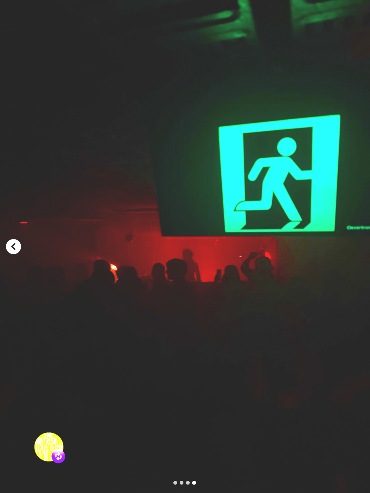 Dark nightclub scene with silhouettes of people and a large illuminated green emergency exit sign showing a running figure.