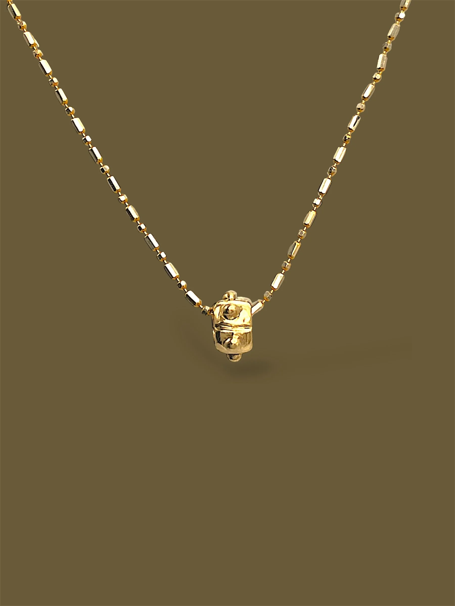 9k-yellow-gold-meditation-pendant-background-minjoo-jewellery.JPG