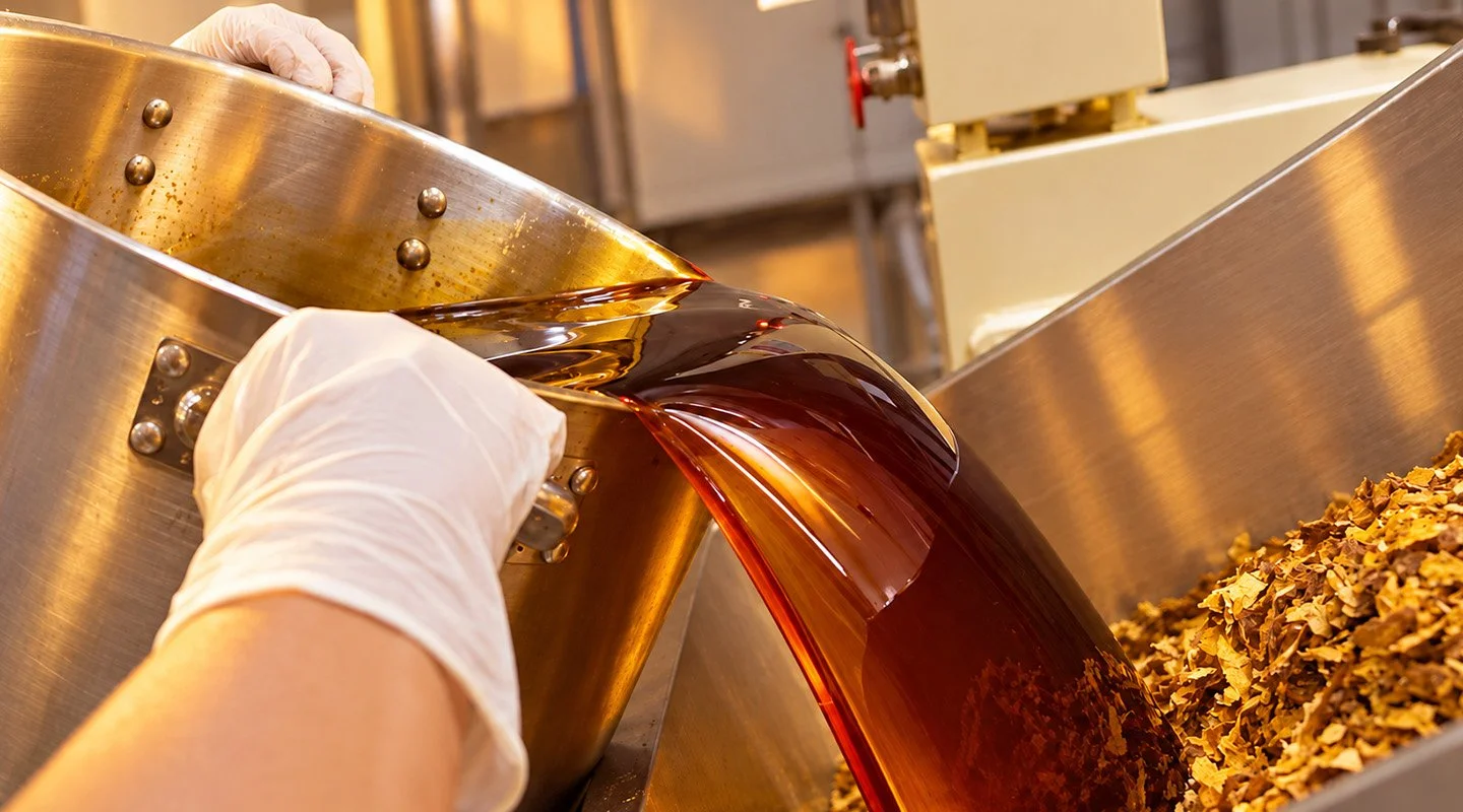 Molasses being poured into tobacco during the Al Fakher shisha blending process at the production facility.