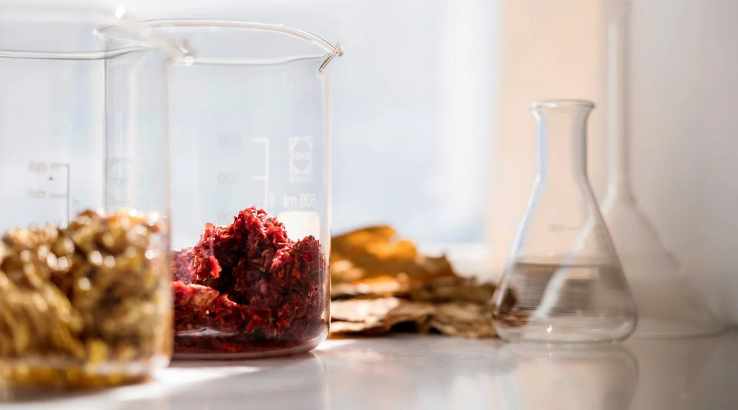 Laboratory glassware with shisha ingredients used for quality and safety testing.