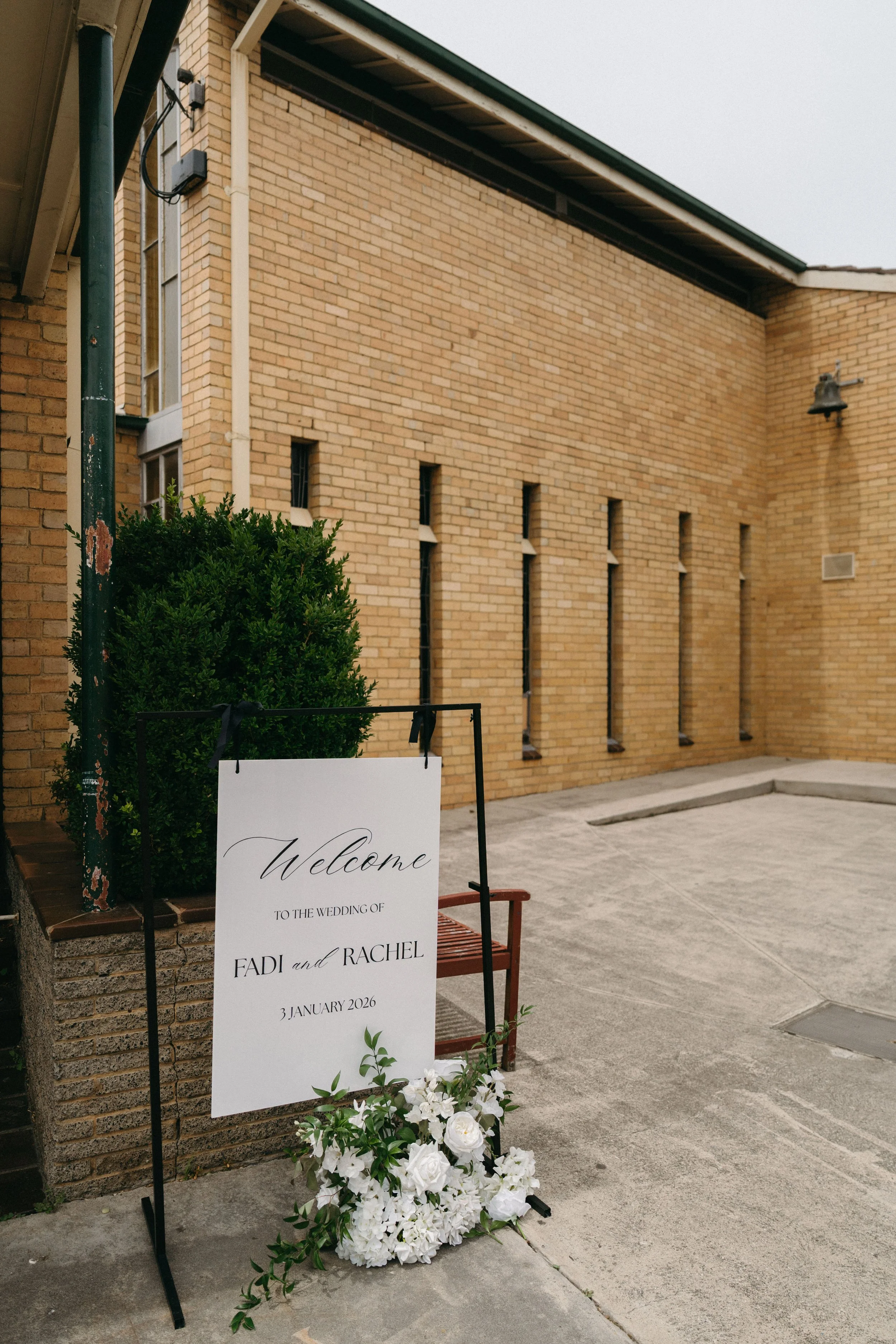 white wedding sign on stand